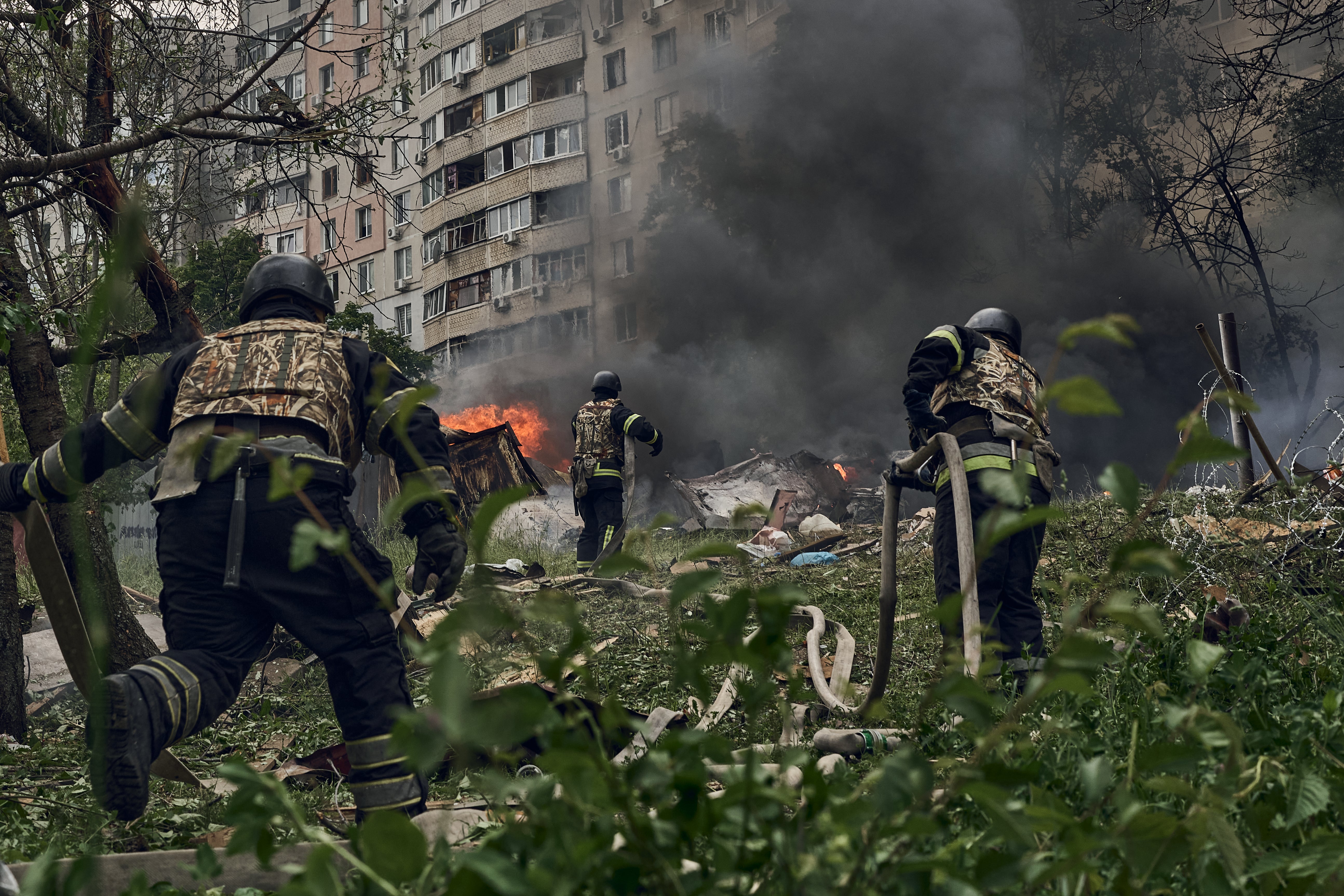 Emergency services fight to extinguish a fire following a Russian airstrike on Kharkiv, Ukraine