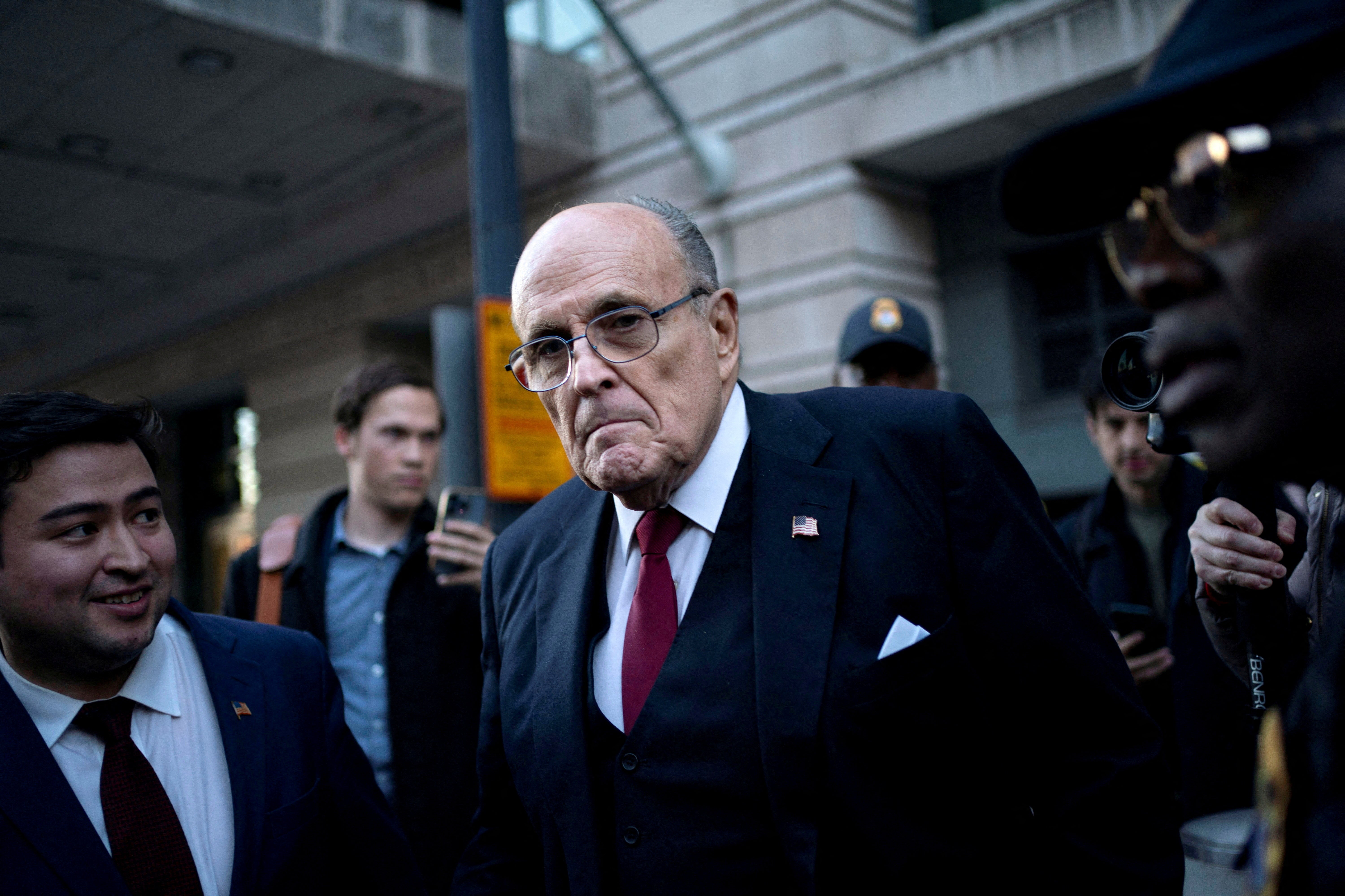 Former New York Mayor Rudy Giuliani departs the US District Courthouse after he was ordered to pay $148m in his defamation case in Washington on December 15 2023