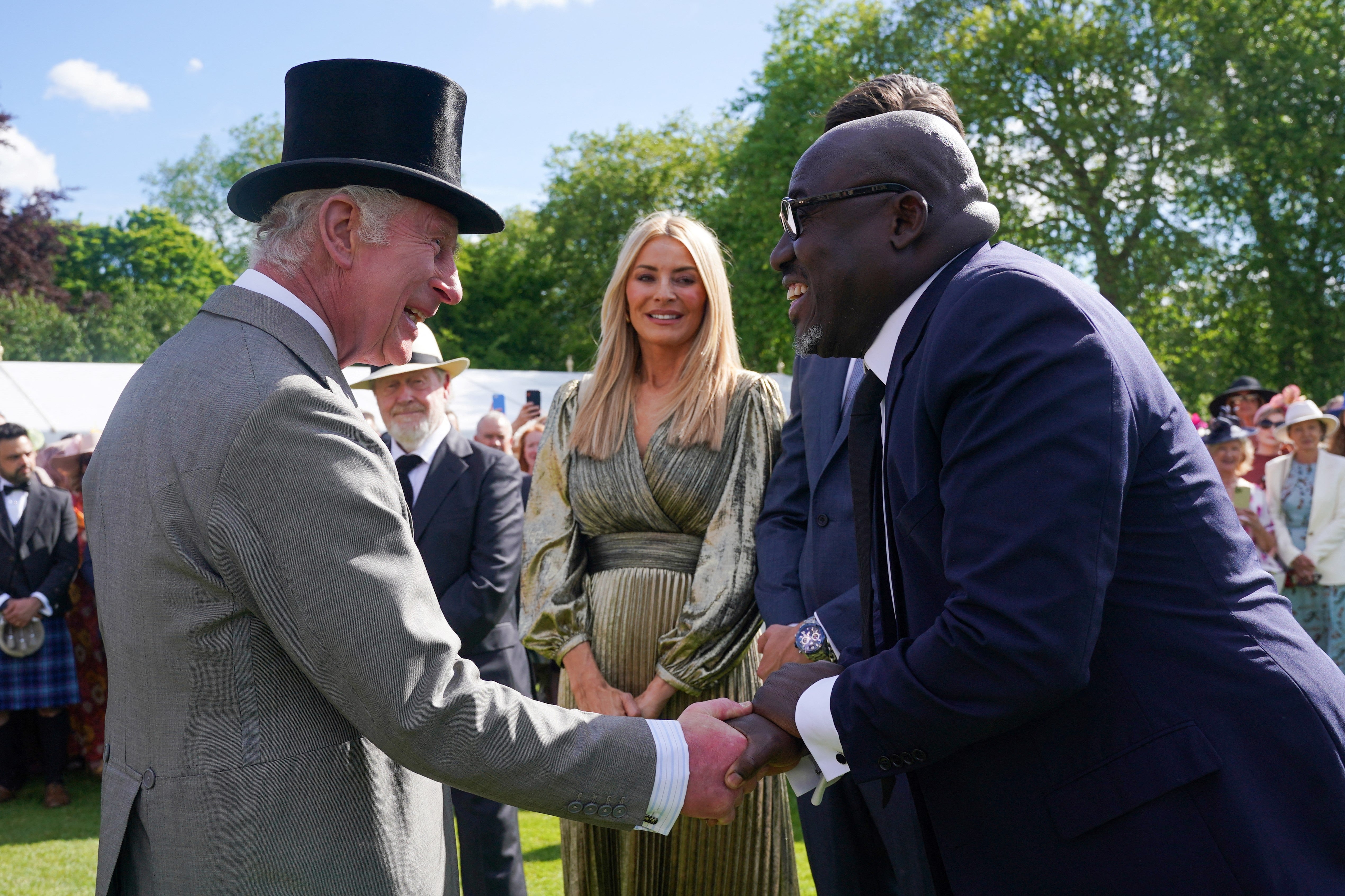 British Vogue's Global Creative and Cultural Advisor Edward Enninful (R) shakes hands with the King