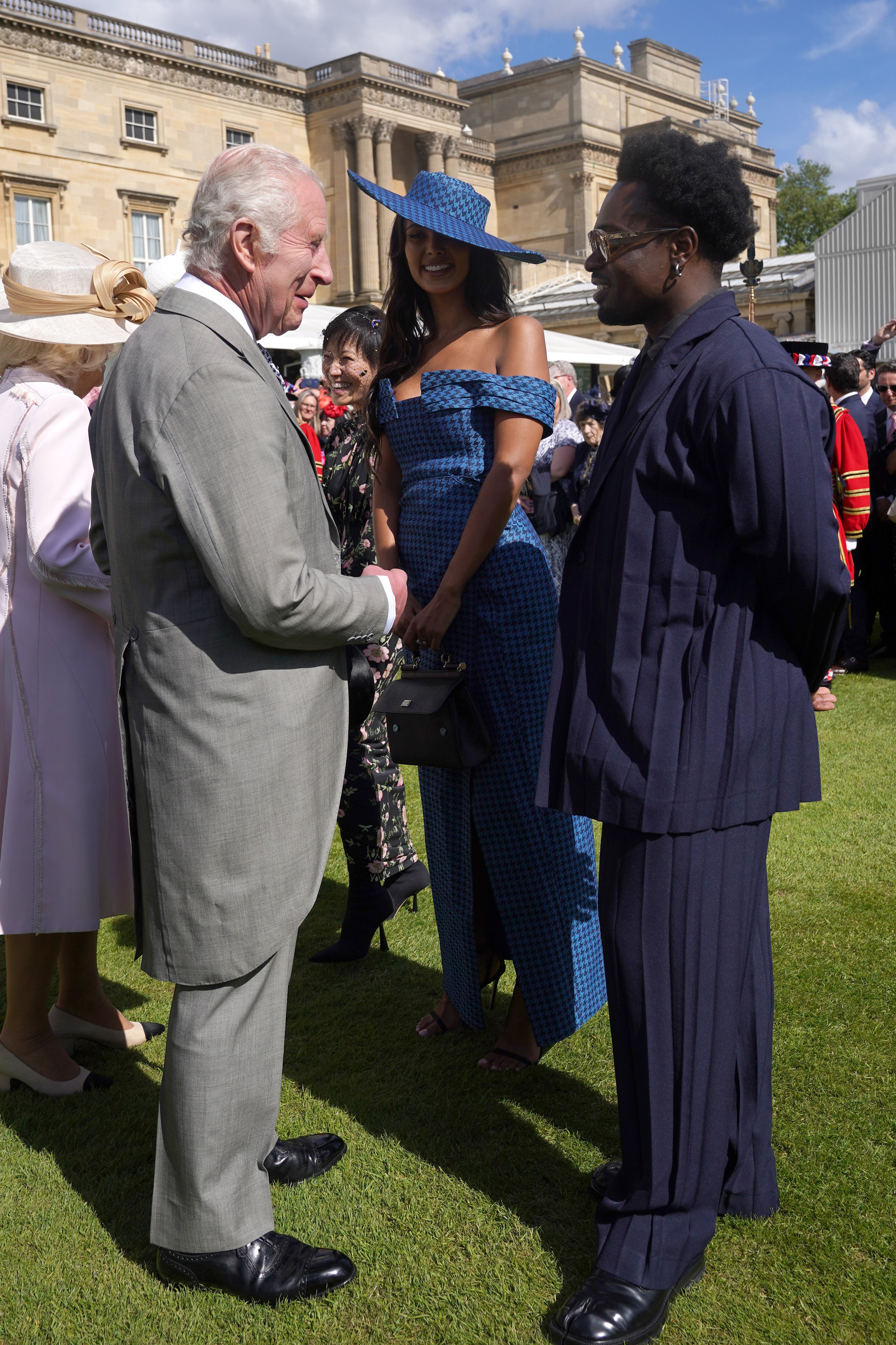 Maya Jama and Campbell Addy speaking to the King about whether he watches Love Island