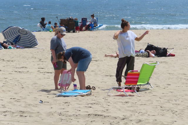 <p>People sit on the beach on a weekday afternoon in Ocean Grove, N.J. on May 2, 2024</p>