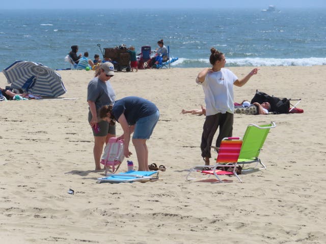 <p>People sit on the beach on a weekday afternoon in Ocean Grove, N.J. on May 2, 2024</p>