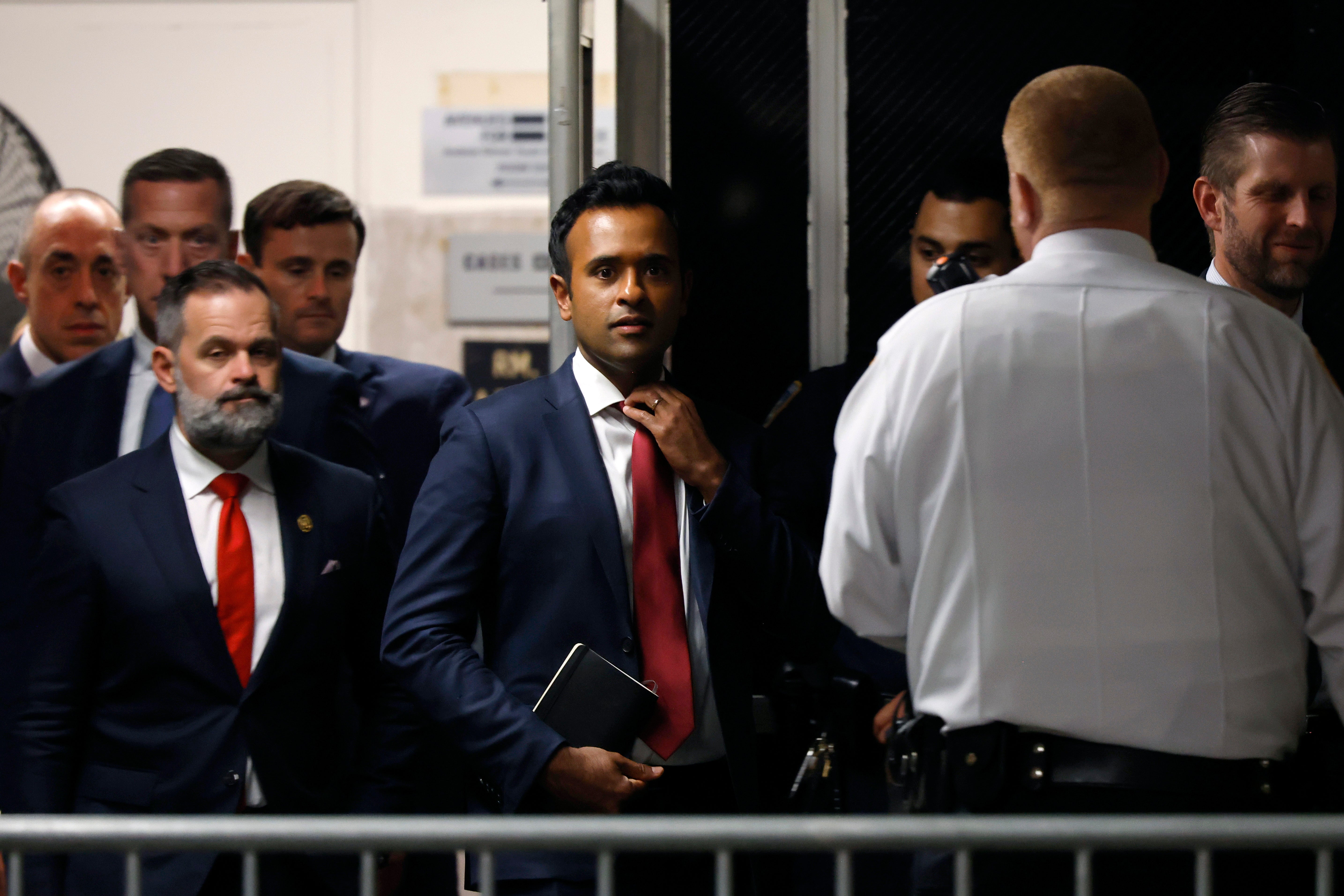 Vivek Ramaswamy, center, and US Rep Cory Mills, left, enter a Manhattan courtroom to observe Donald Trump’s hush money trial on 14 May.