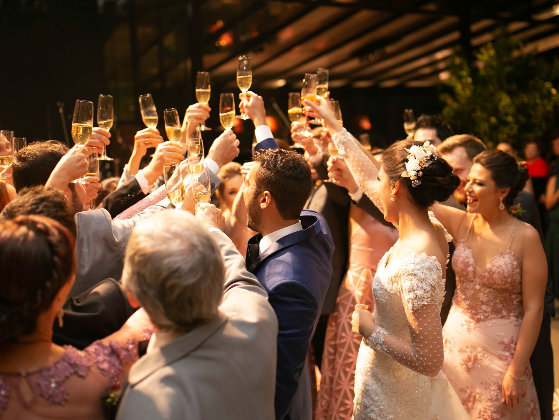 Bride, groom and wedding guests making a toast