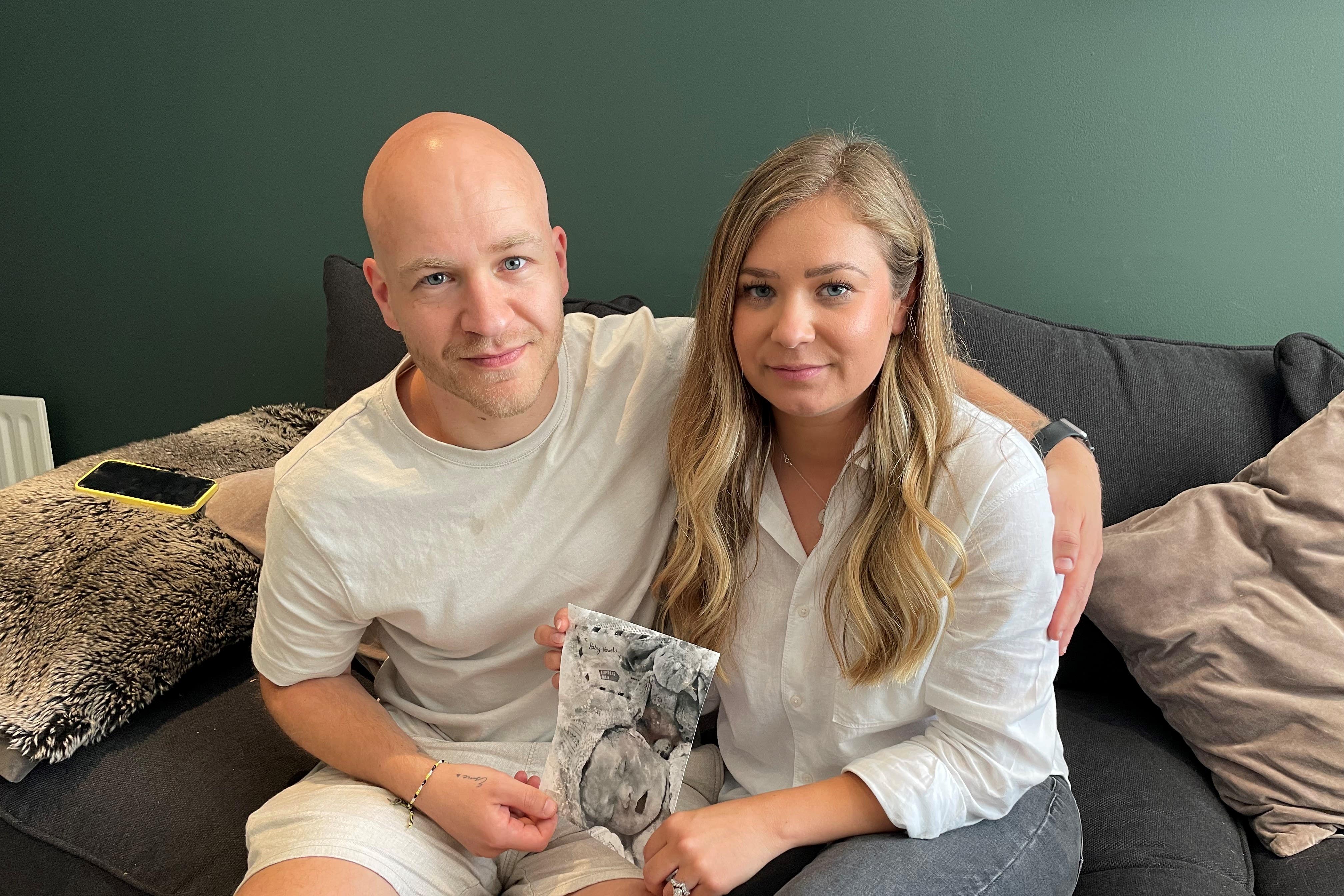 Chloe Vowels Lovett and Toby Lovett hold a picture of their baby Esme (PA)