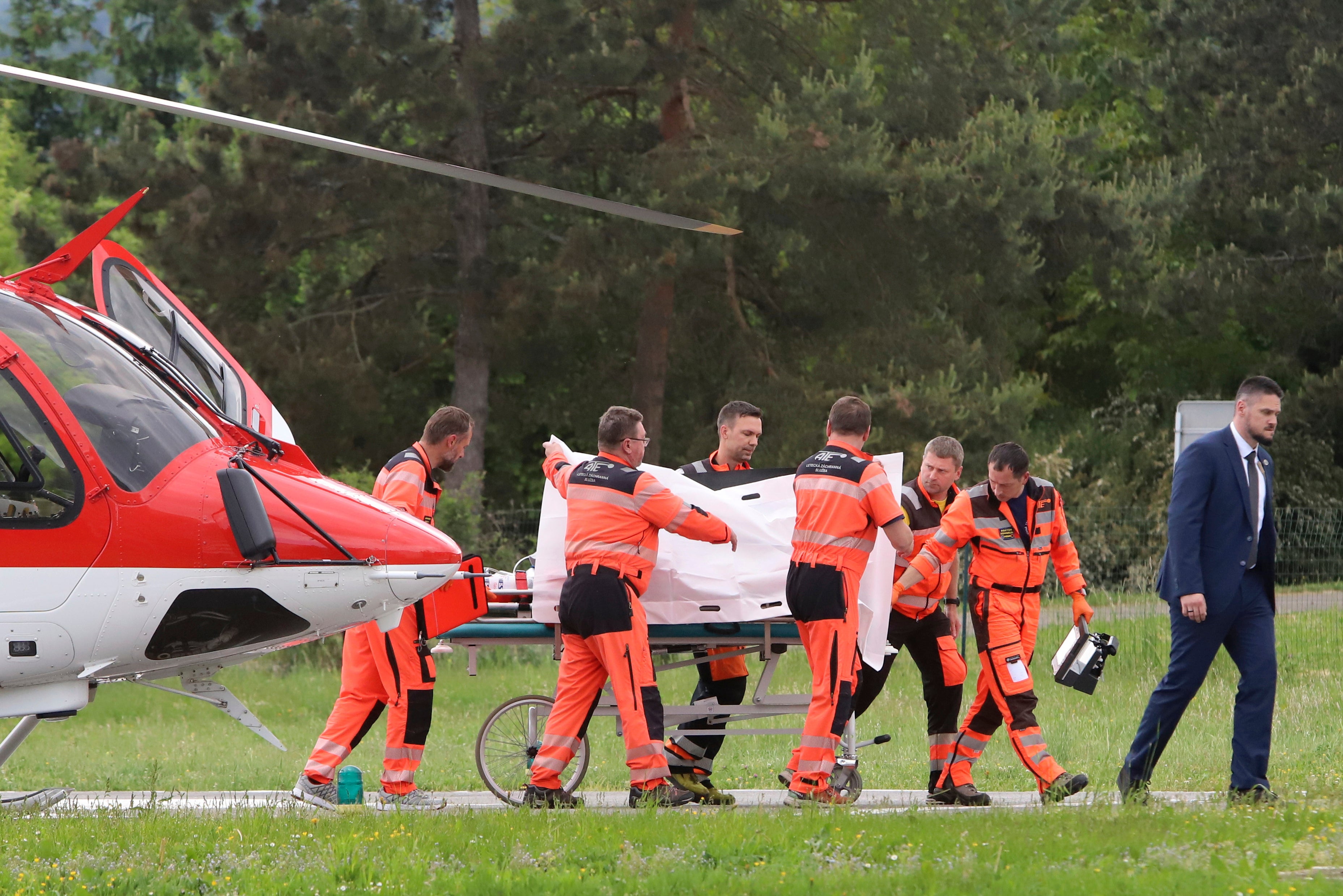 Slovak prime minister Robert Fico is wheeled to hospital after he was shot and injured