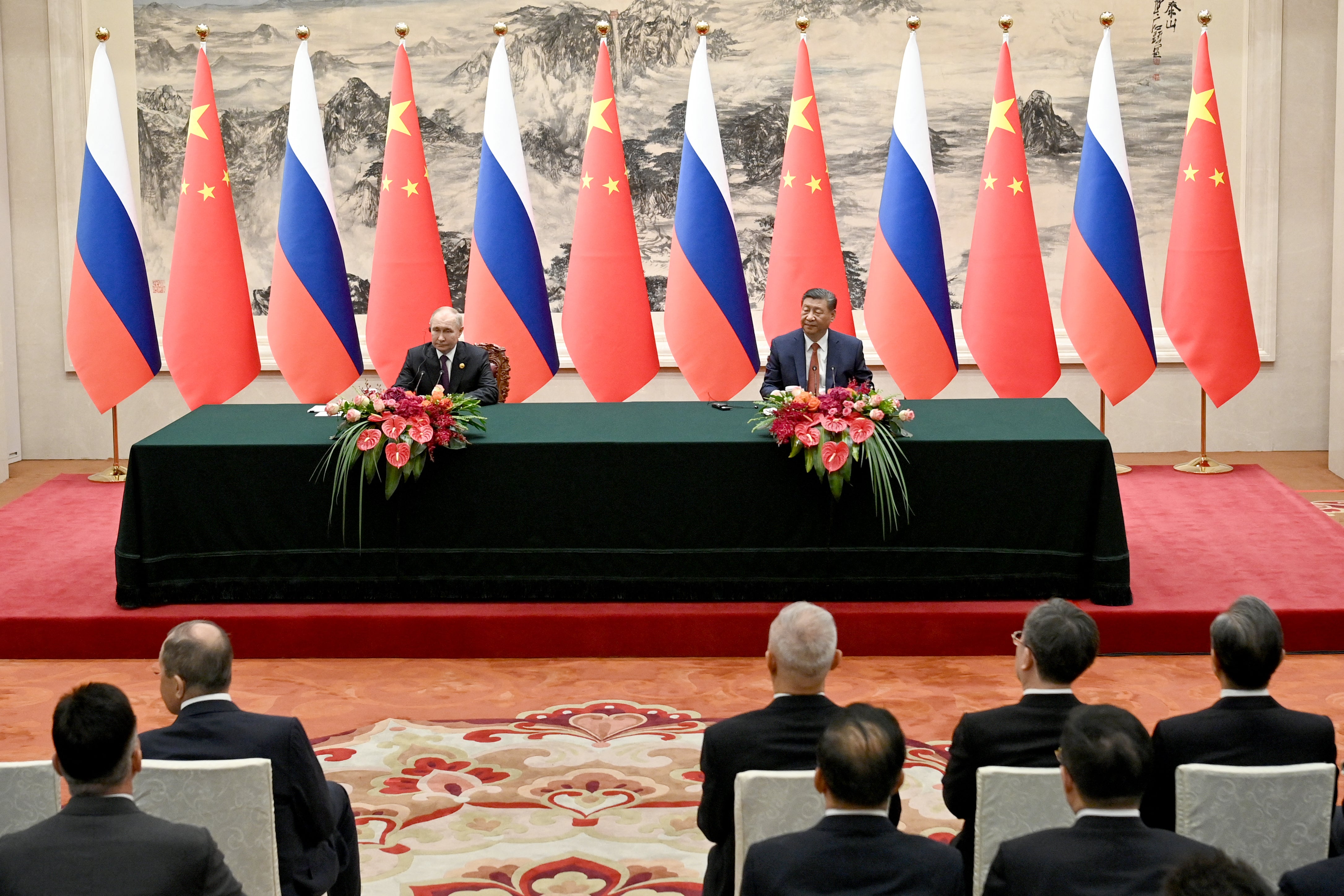 In this pool photograph distributed by the Russian state agency Sputnik, Russia's President Vladimir Putin and China's President Xi Jinping attend a signing ceremony following their talks in Beijing
