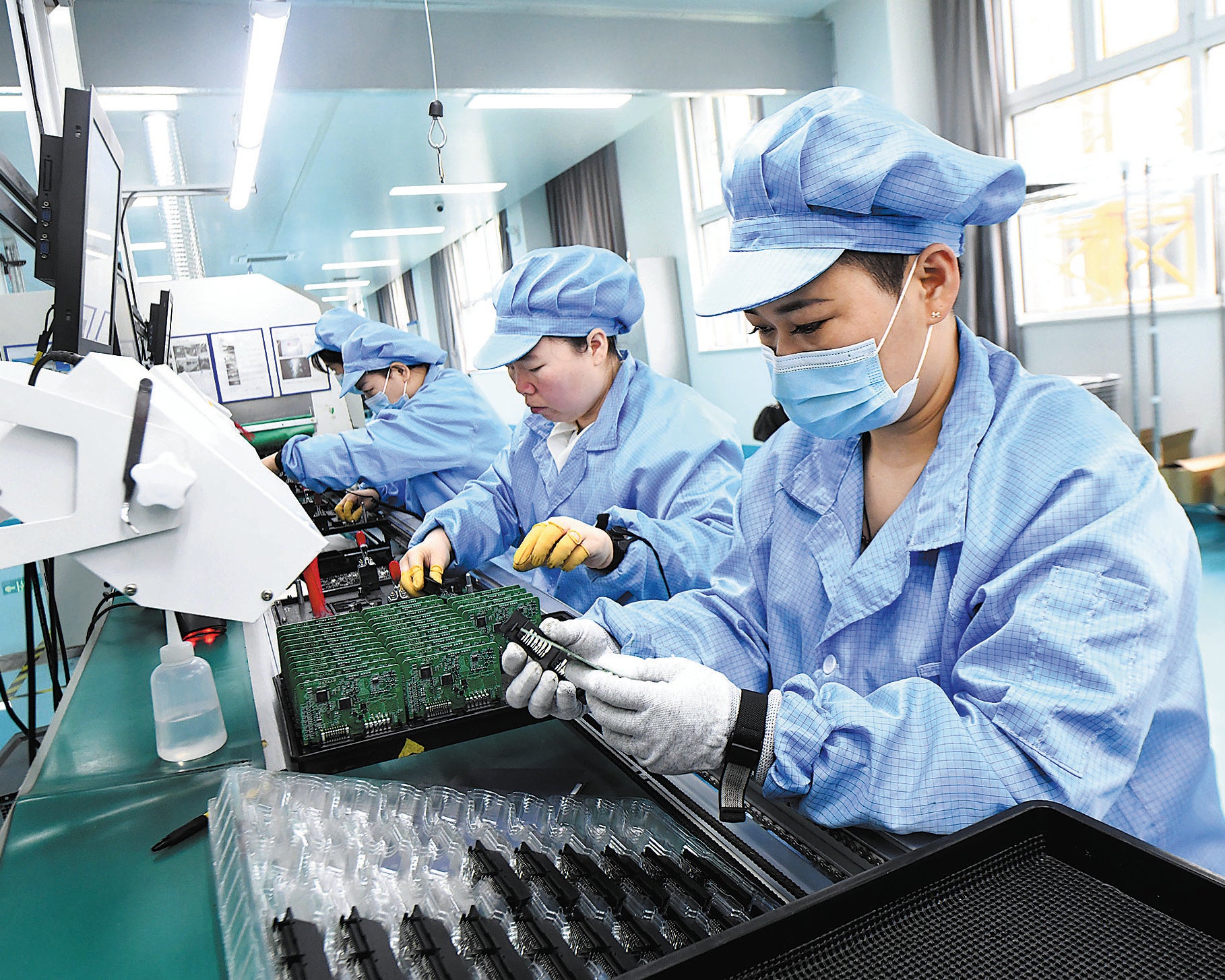 Employees work on a production line of export-bound electronics in Shijiazhuang, Hebei province