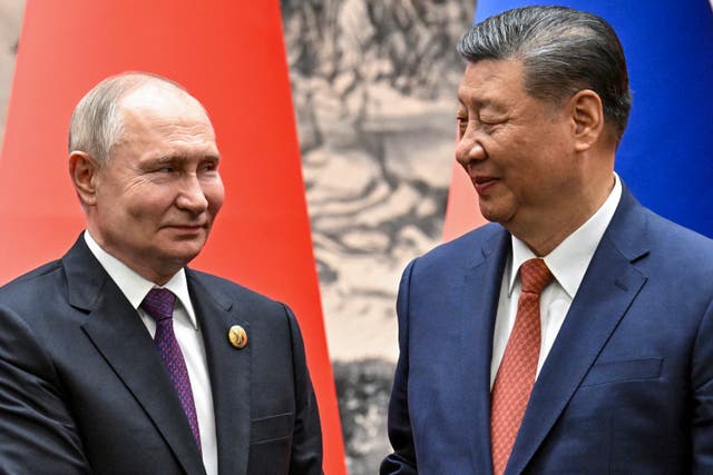 <p>Chinese President Xi Jinping, right, and Russian President Vladimir Putin shake hands prior to their talks in Beijing, China</p>