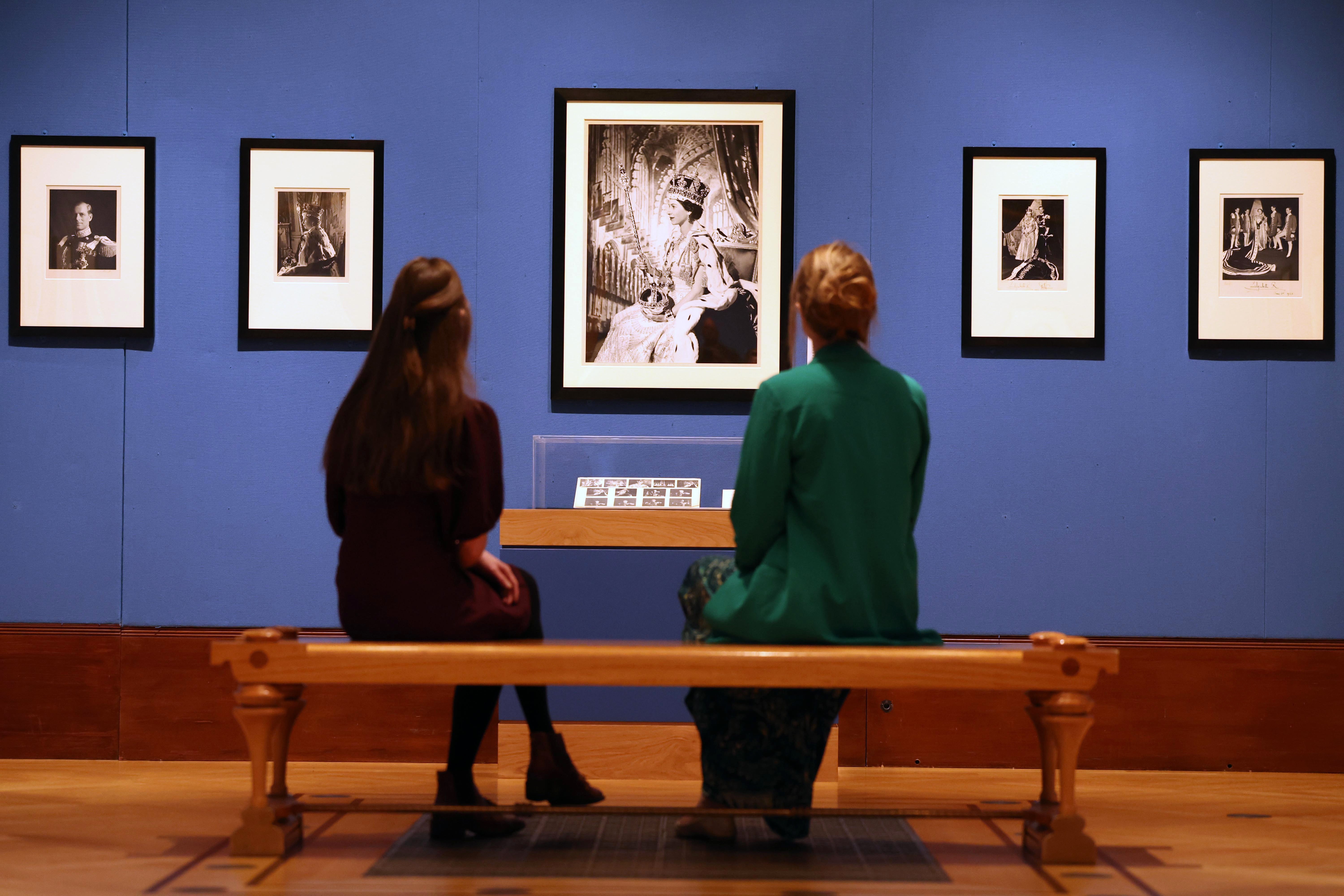 Gallery workers view photographs of Queen Elizabeth II by Cecil Beaton