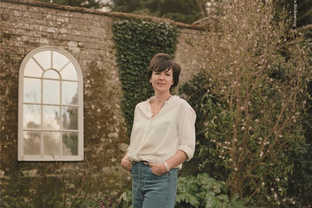 <p>Olivia Laing in their Suffolk garden</p>
