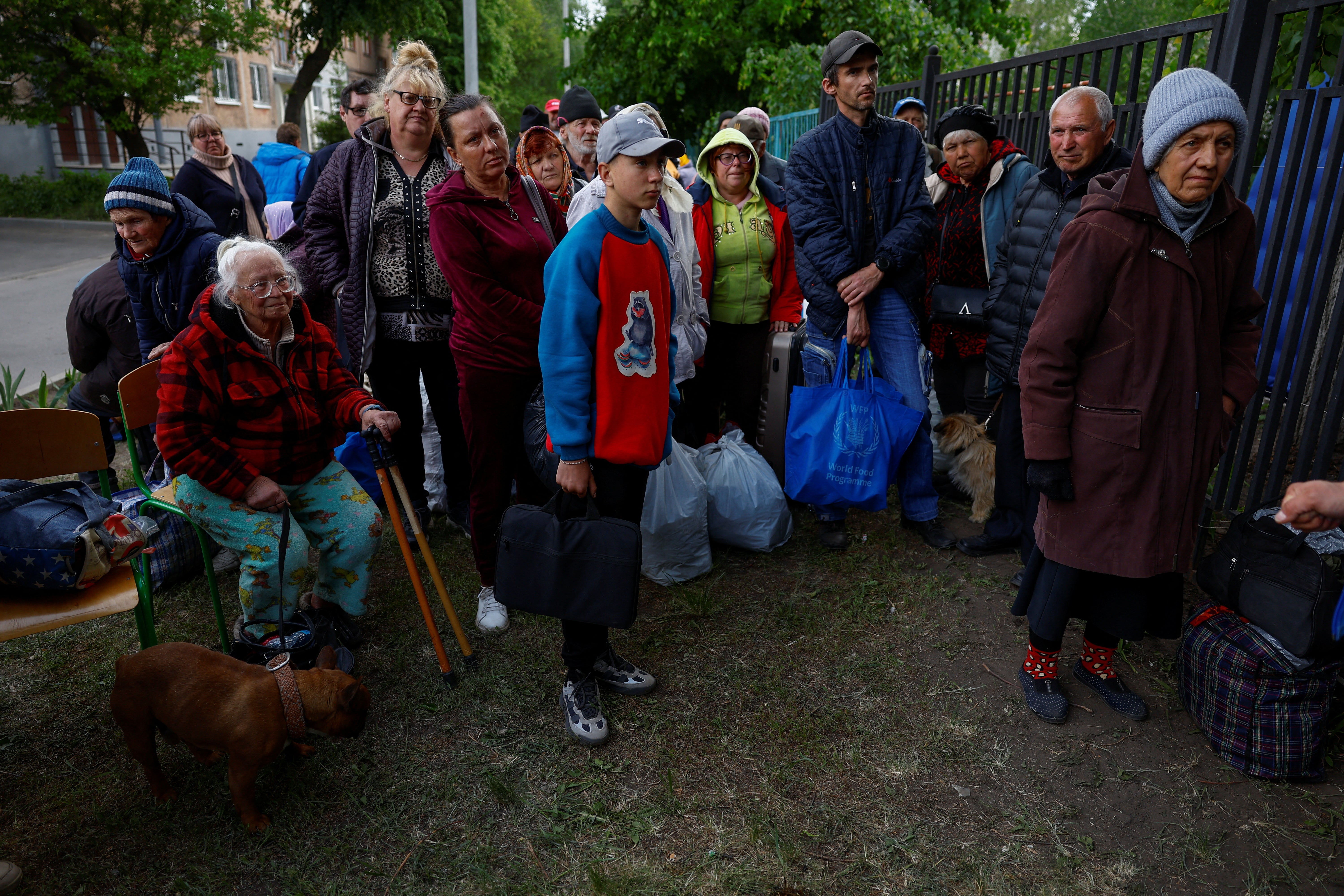 Vovchansk area residents, who fled due to Russian military strikes, gather at an evacuation centre compound in Kharkiv region