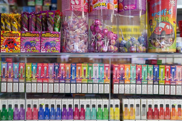 <p>Vape flavours next to sweets in a shop</p>