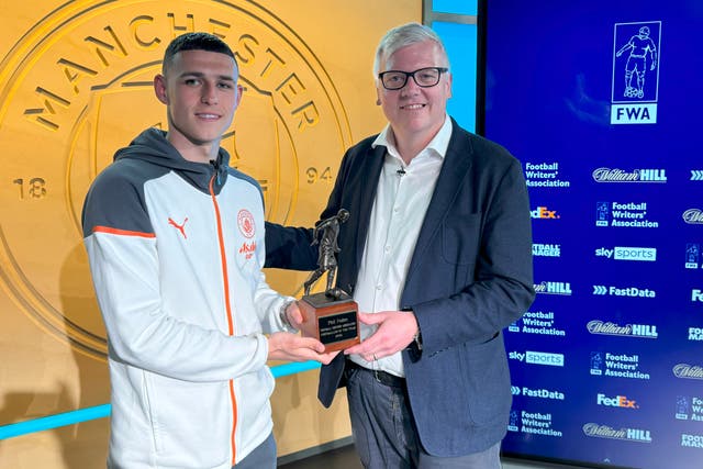 <p>Phil Foden was presented his trophy by FWA Chair John Cross.</p>
