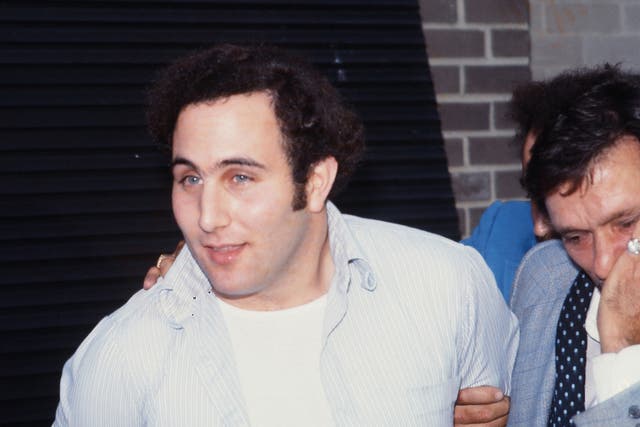 <p>Police officers escort serial killer David Berkowitz, known as the Son of Sam, into the 84th precinct station on August 10, 1977. </p>
