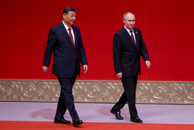 <p>Song and dance: Vladimir Putin and Xi Jinping attend a concert celebrating 75 years of relations between Russia and China</p>