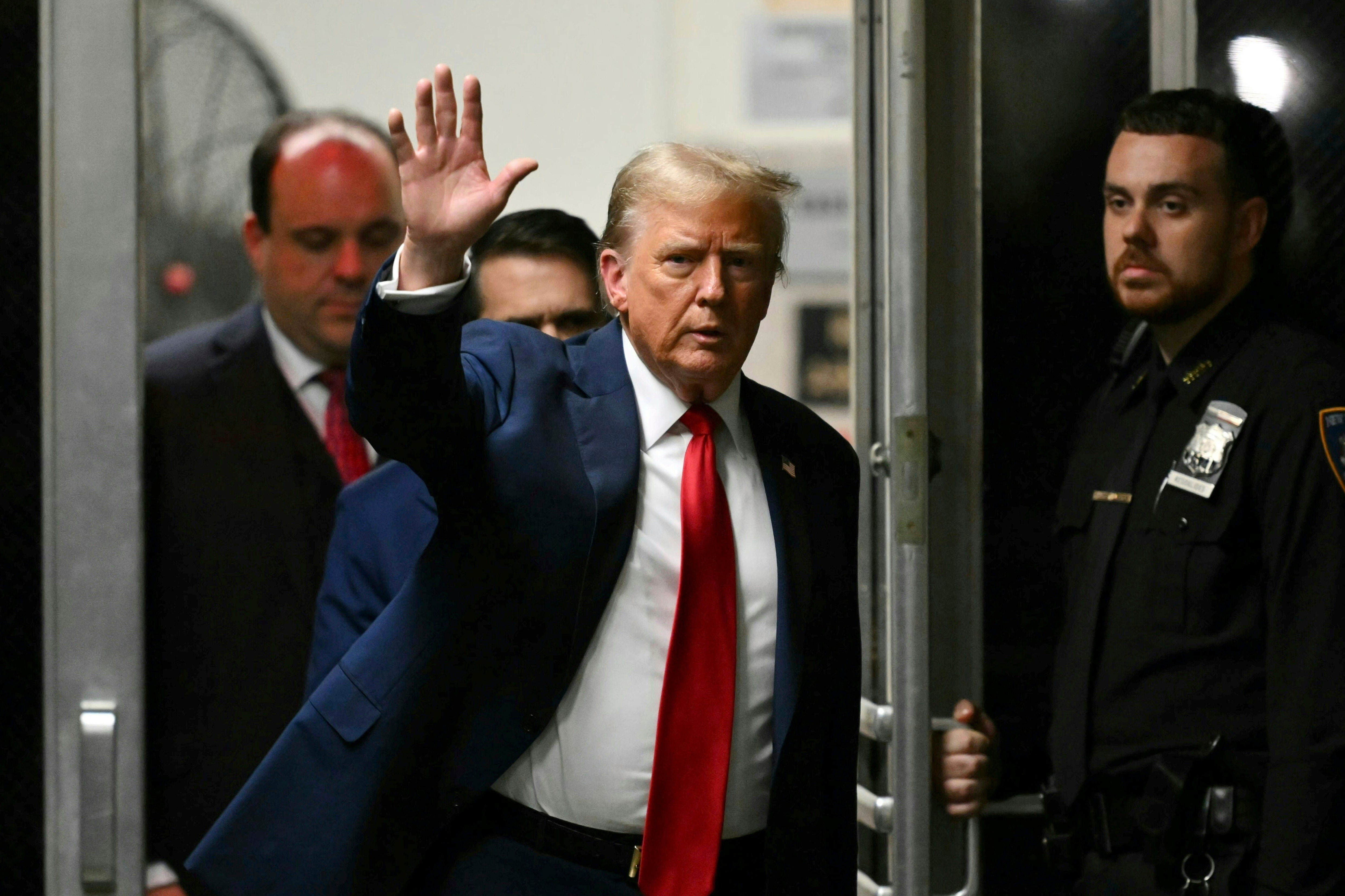 Former President Donald Trump waves as he returns to the courtroom after a break in his trial at Manhattan criminal court Thursday, May 16, 2024, in New York