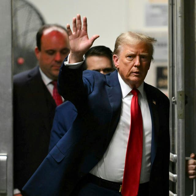 <p>Former President Donald Trump waves as he returns to the courtroom after a break in his trial at Manhattan criminal court Thursday, May 16</p>