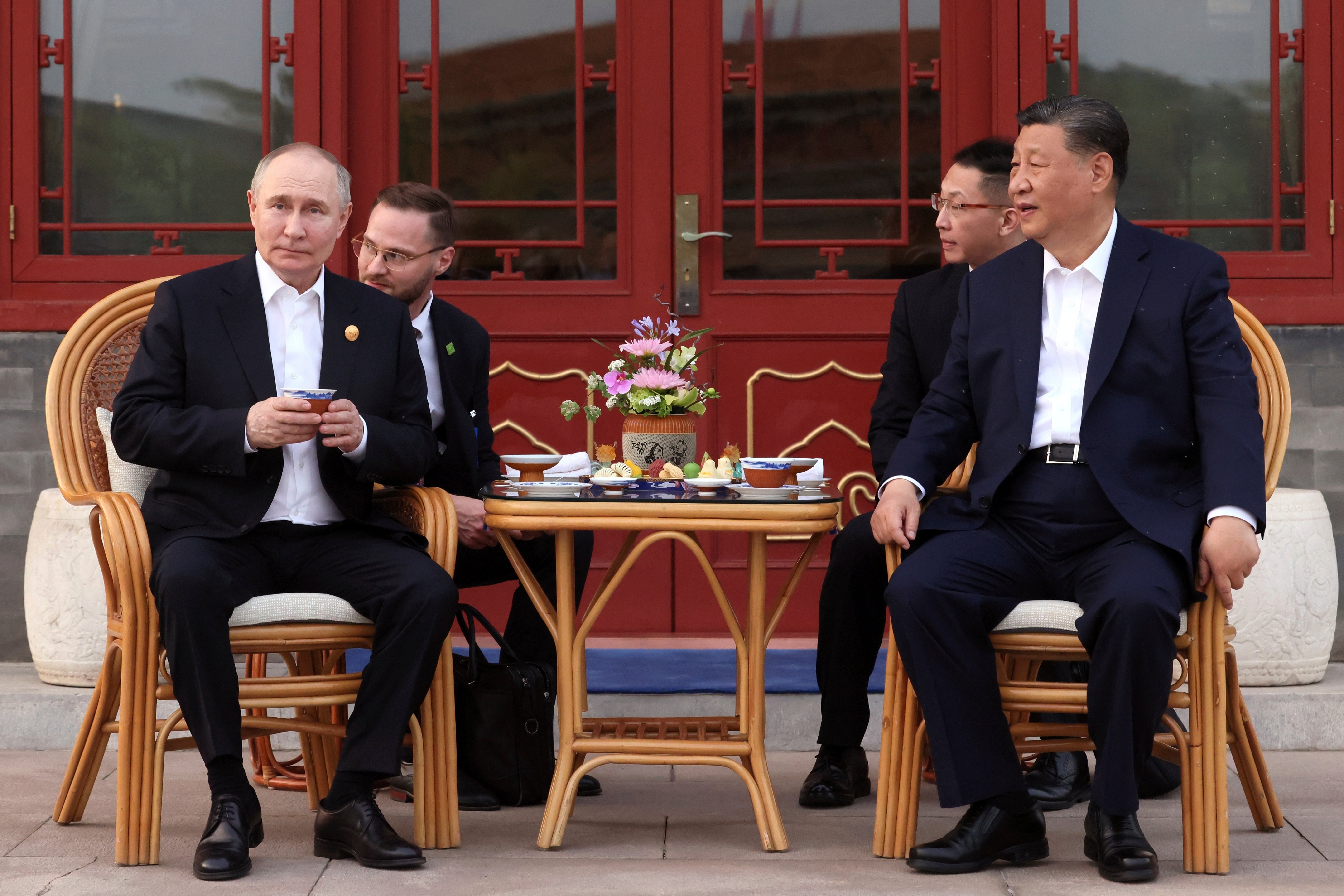 Vladimir Putin and Xi Jinping attend an informal meeting in Beijing