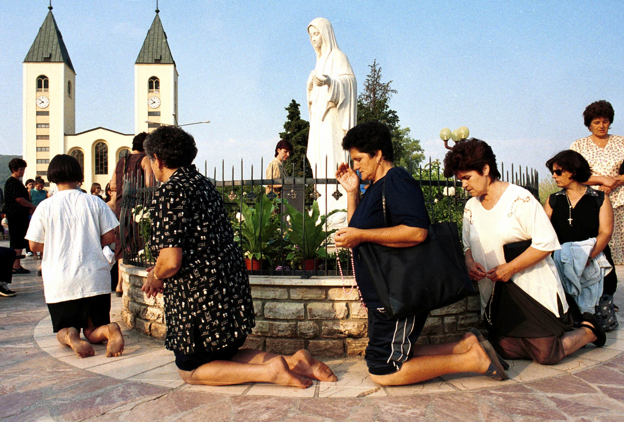 Bosnian Roman Catholic women pray on the occasion of the feast of the Assumption in Medjugorje
