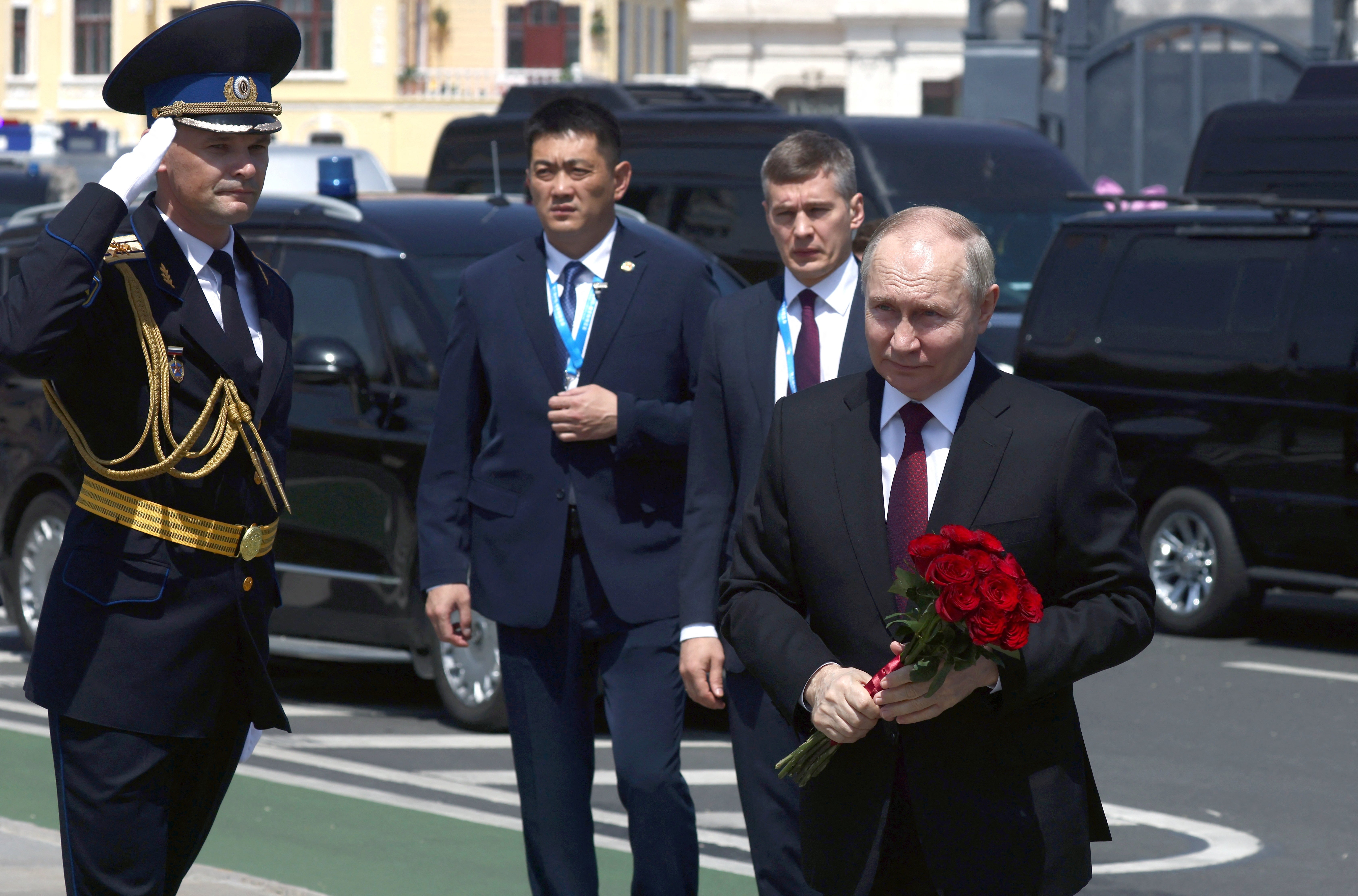 Russian President Vladimir Putin takes part in a flower-laying ceremony at a monument to Soviet soldiers, who died in battles for the liberation of China, in Harbin, China