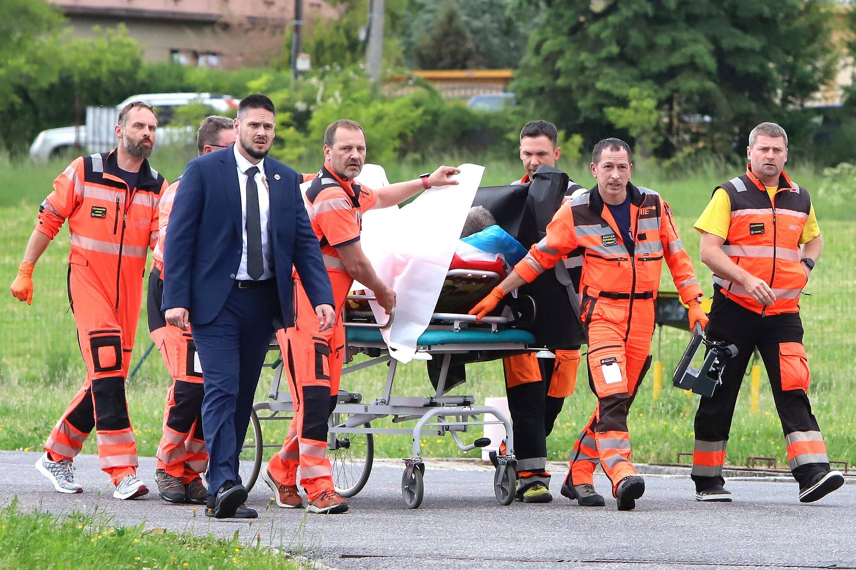 Rescue workers wheel shot Slovak Prime Minister Robert Fico to a hospital in the town of Banska