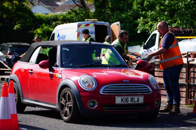 People collecting bottled water at Broadsands Car Park in Paignton (Ben Birchall/PA)