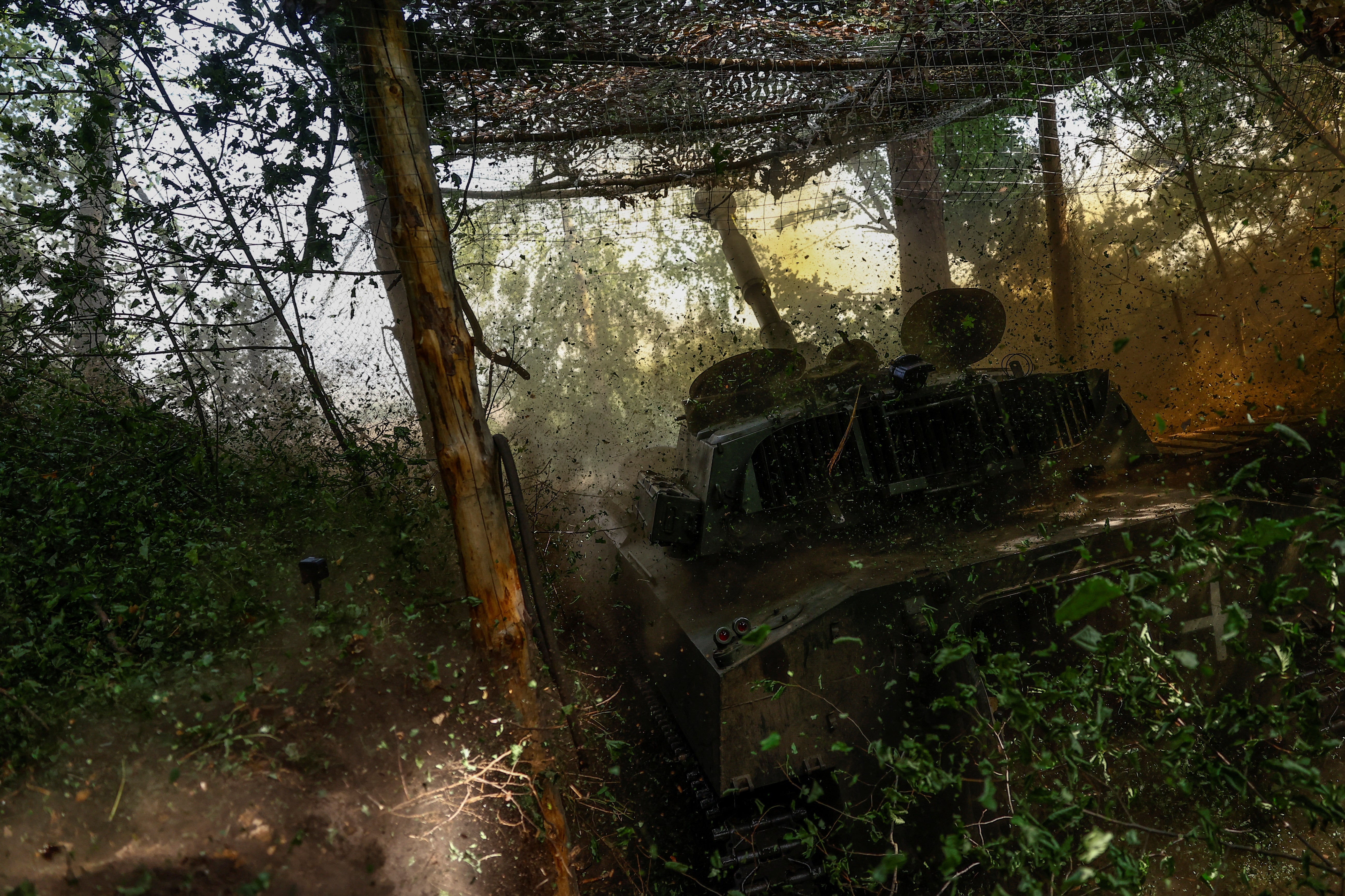 Ukrainian servicemen of the 42nd Separate Mechanized Brigade fire a 2S1 Gvozdika self-propelled howitzer towards Russian troops in the Kharkiv region