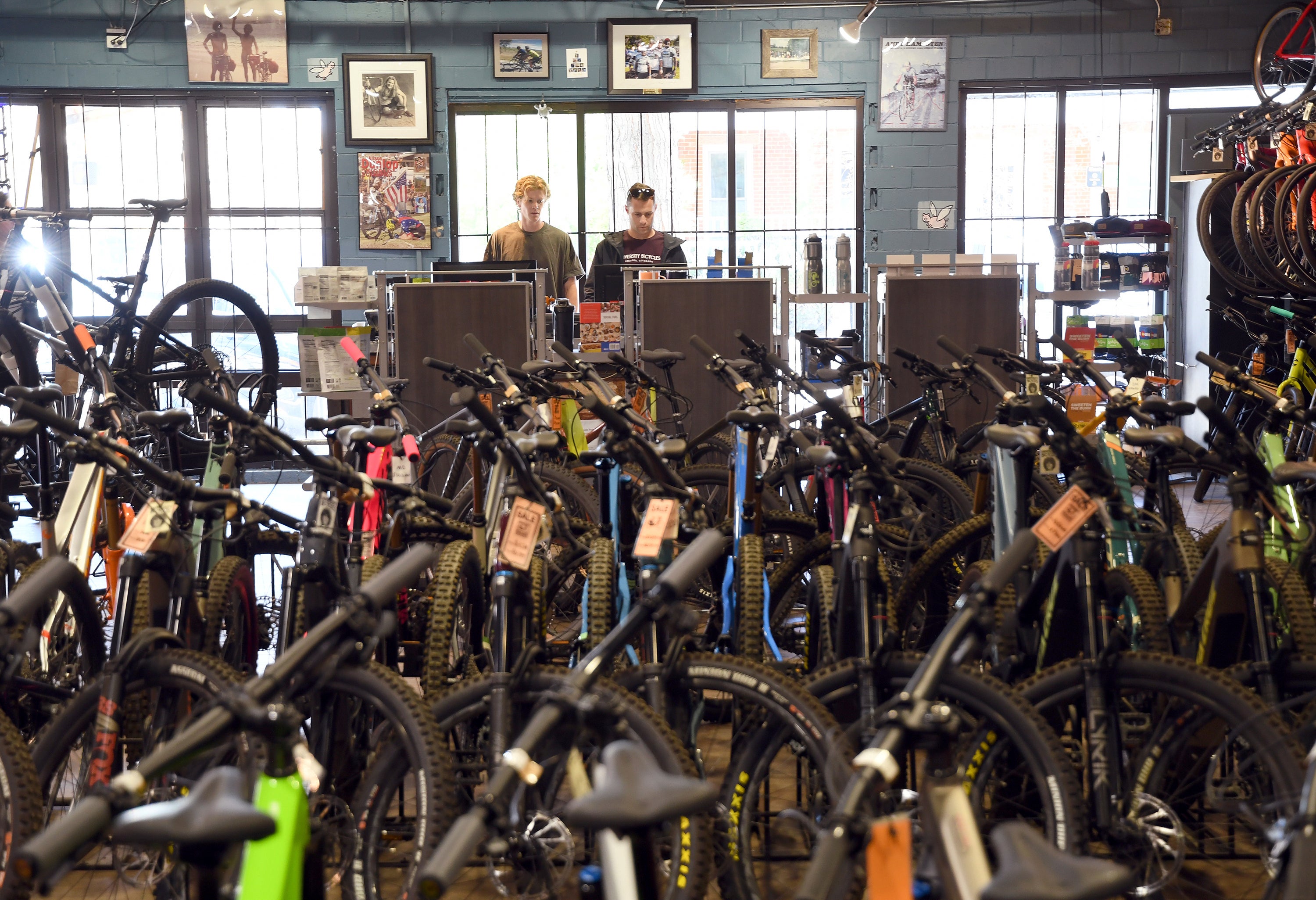 Salesmen Will Malfeld, left, and Ben Chandler, right, work at University Bicycles in Boulder