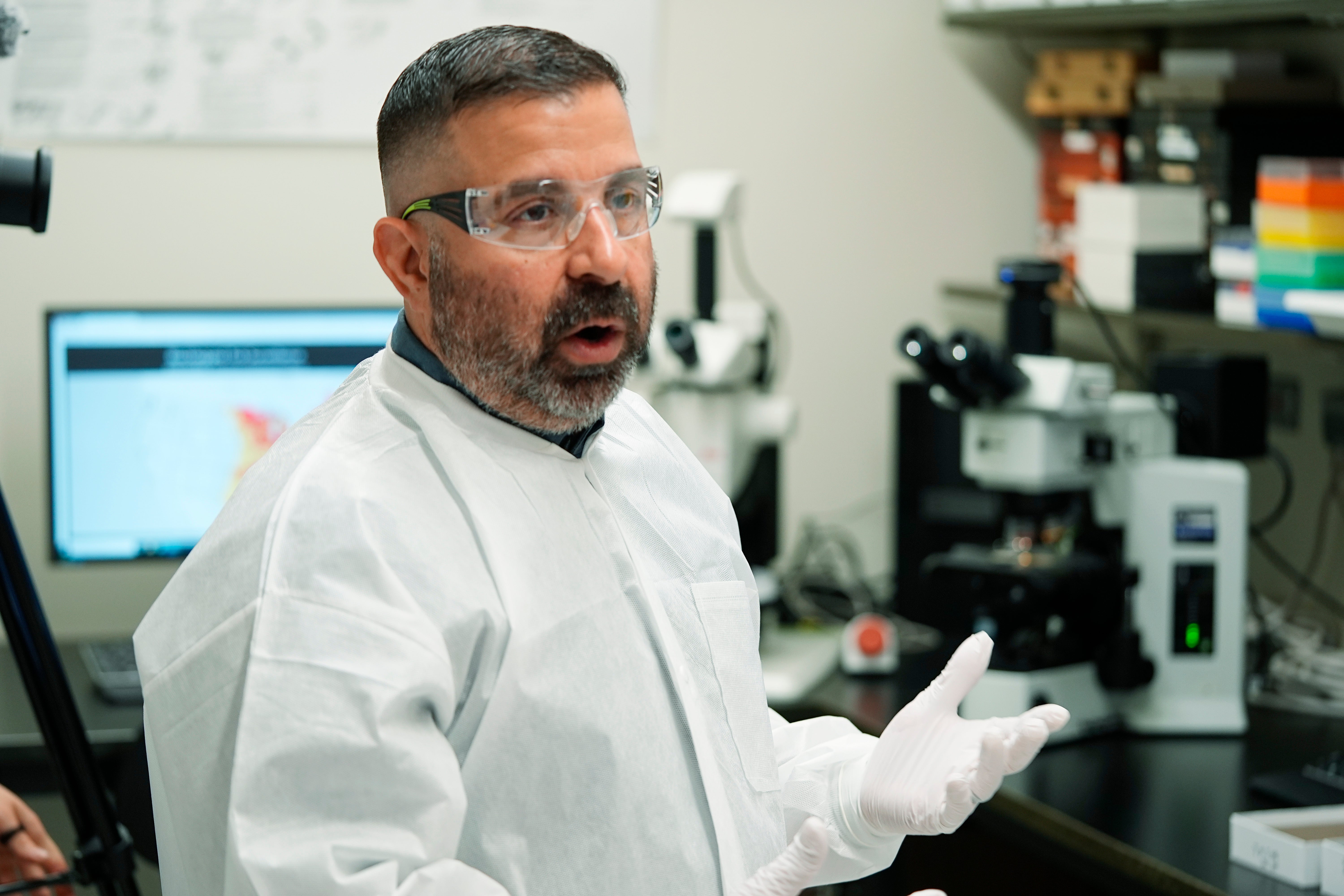 Researcher Erik Foster talks in his laboratory about ticks during a tour of the Center for Disease Control