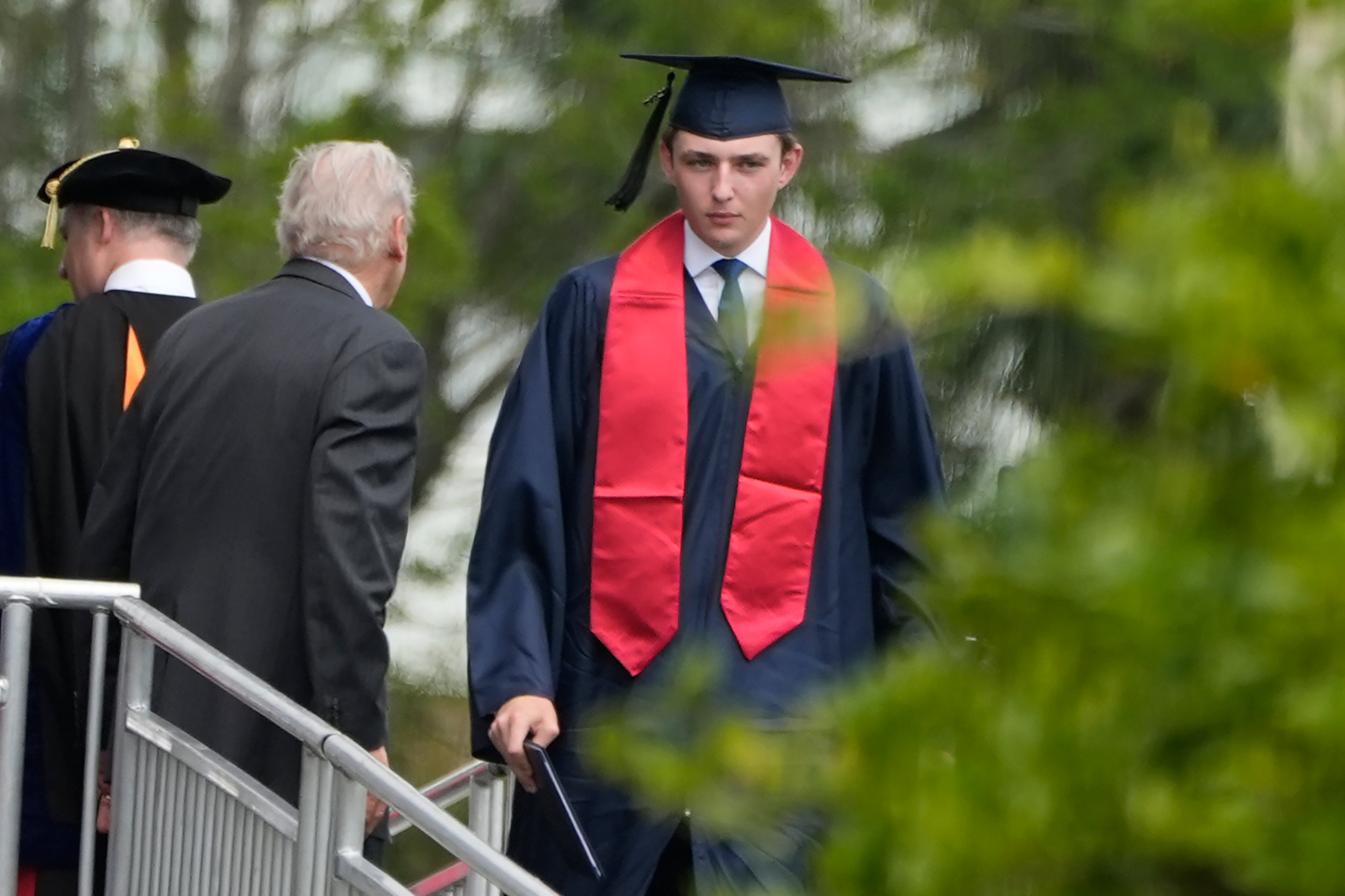 Barron Trump walks after receiving his diploma during his graduation ceremony at Oxbridge Academy