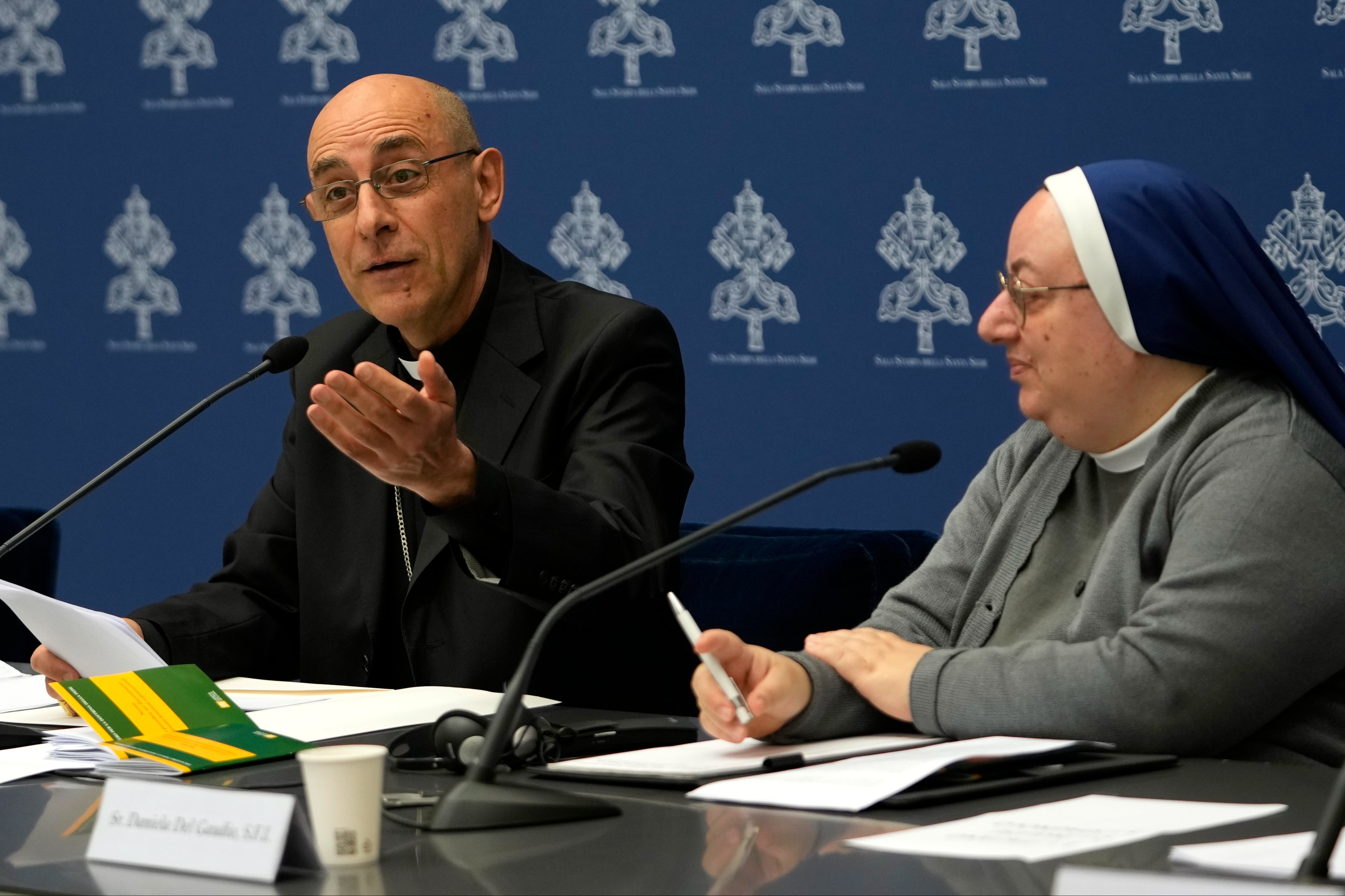 Argentine Cardinal Victor Manuel Fernandez, left, head of the Vatican doctrine office, is flanked by Sister Daniela del Gaudio, head of he Observatory on Marian Apparitions and Mystical Phenomenon, during a press conference at the Vatican