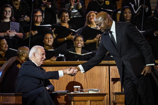 <p>US Senator Raphael Warnock, the pastor at Ebenezer Baptist Church, greets US President Joe Biden during a worship service in Atlanta, Georgia, on 15 January 15 2023</p>