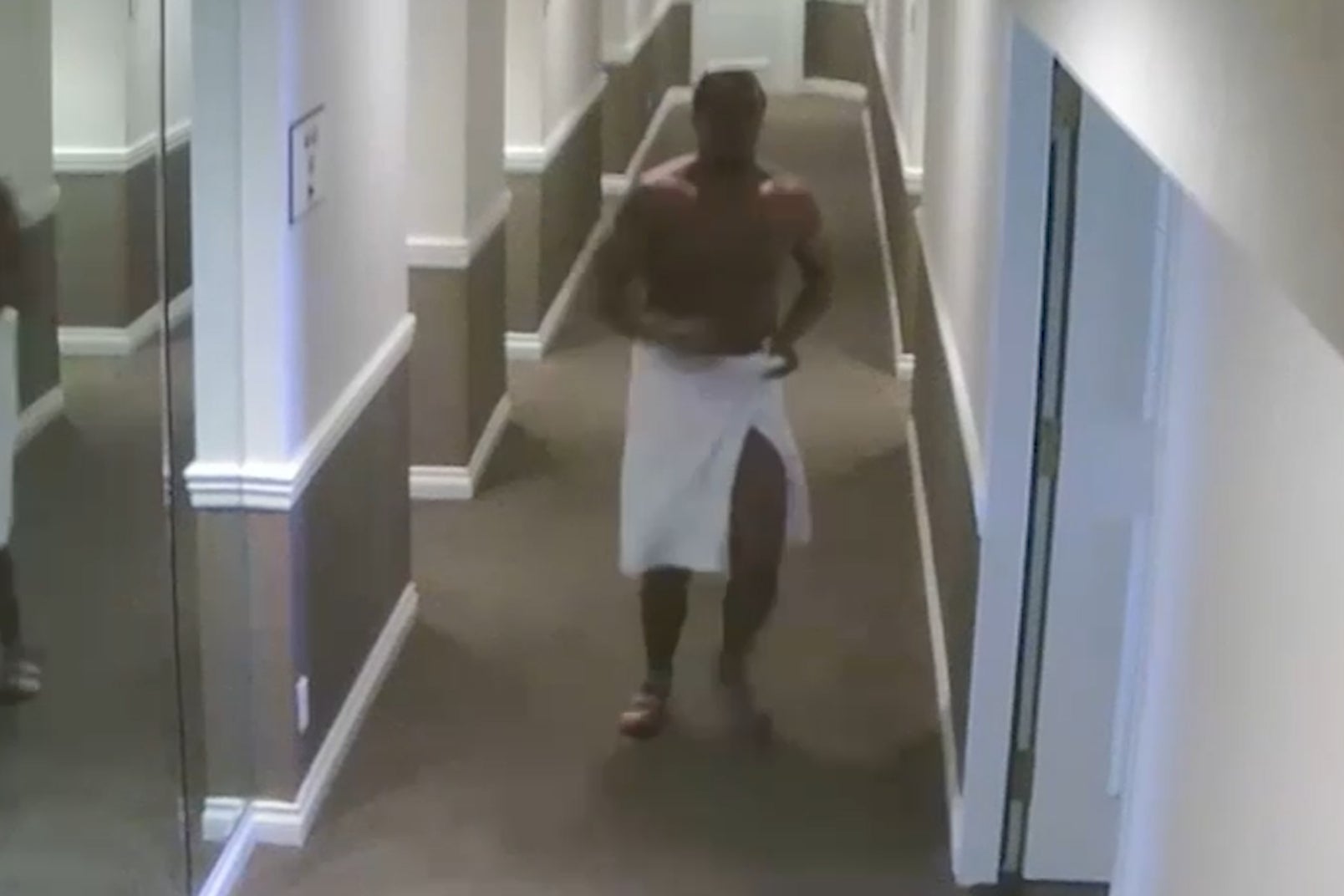 Diddy is seen in a towel chasing Cassie down the corridor towards the elevators, where he attacks her and pushes her to the floor