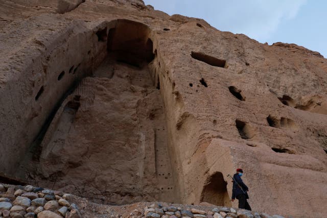 <p>A Taliban soldier stands guard in front of the ruins of a 1500-year-old Buddha statue in Bamiyan</p>
