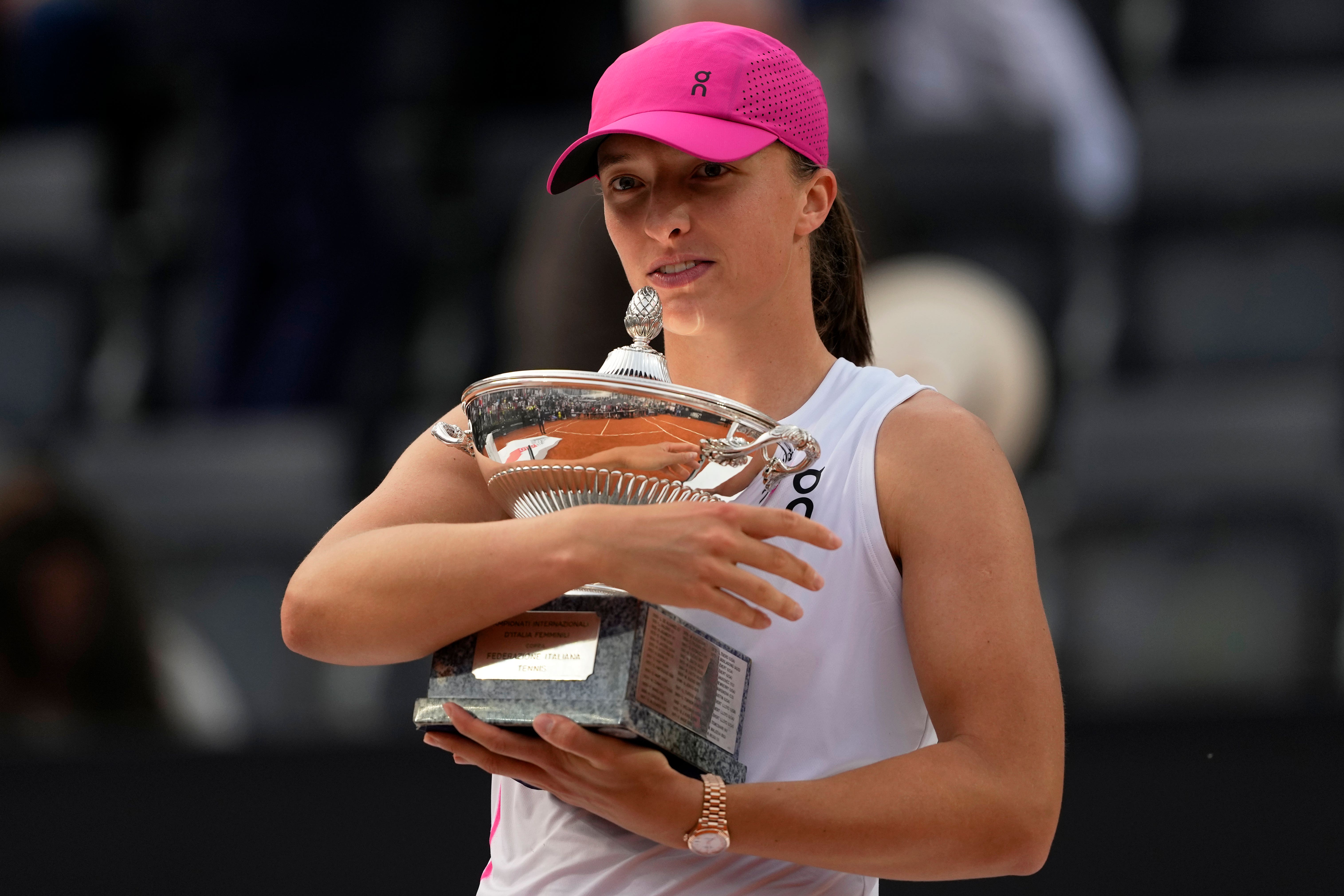 Iga Swiatek poses with the trophy after defeating Aryna Sabalenka in the final of the Italian Open (Alessandra Tarantino/AP/PA)