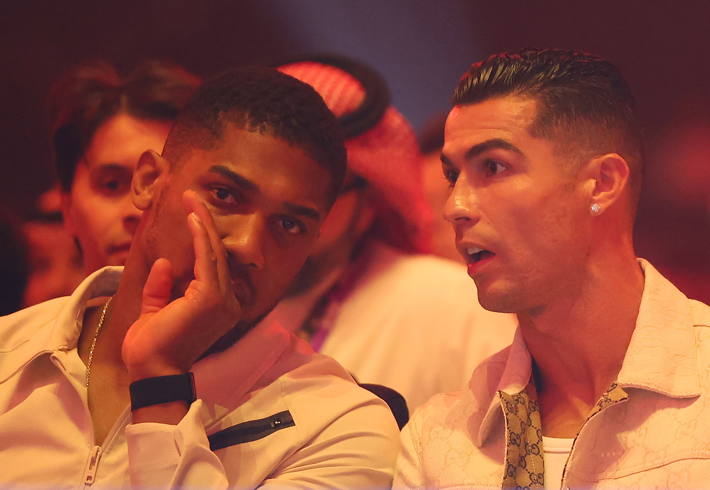 Joshua (left) watching Fury vs Usyk from ringside with Cristiano Ronaldo