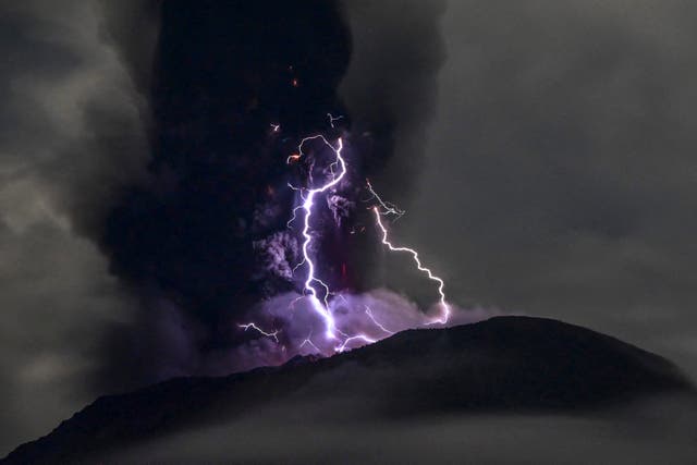 <p>This handout picture taken and released on 18 May 2024 by the Indonesian Geological Agency shows Mount Ibu spewing volcanic ash as lightning strikes</p>