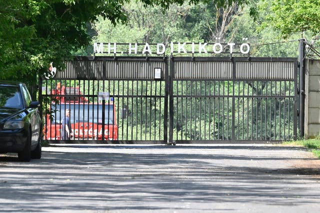 <p>A car of the diving service of the fire brigade is parked behind the closed gate of a military port </p>