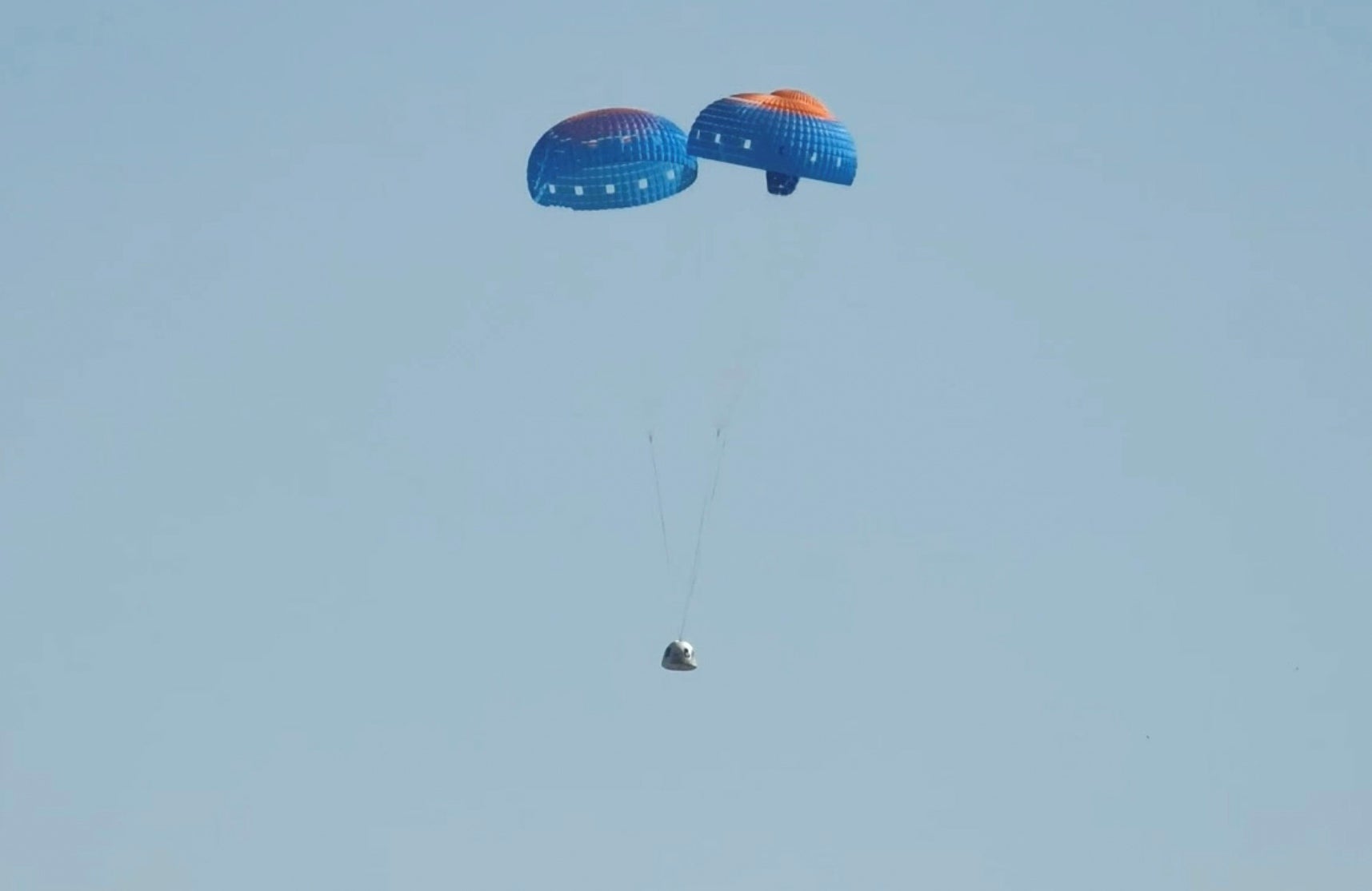 The Blue Origin space capsule carrying six passengers pictured parachuting to a safe landing on Sunday morning in Texas. The flight marked the first time since 2022 the company has sent people into space