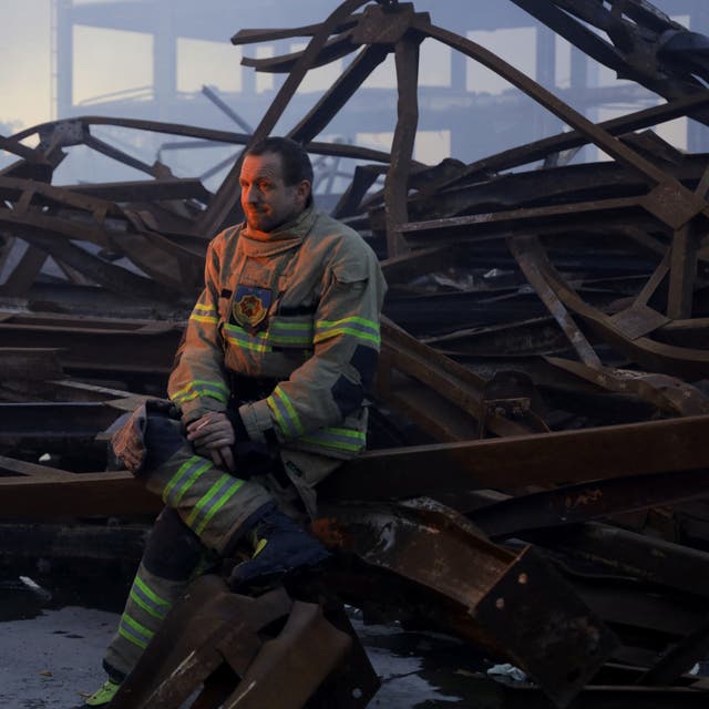 <p>A Ukrainian firefighter takes a rest after putting out a fire in food warehouse after Russian missile strike to Odesa</p>
