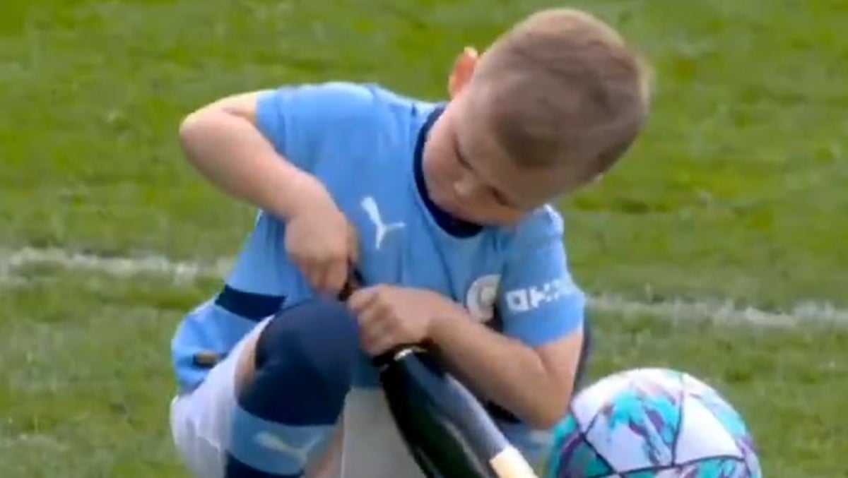 Phil Foden’s five-year-old son Ronnie caught on camera trying to open champagne bottle after Manchester City win Premier League