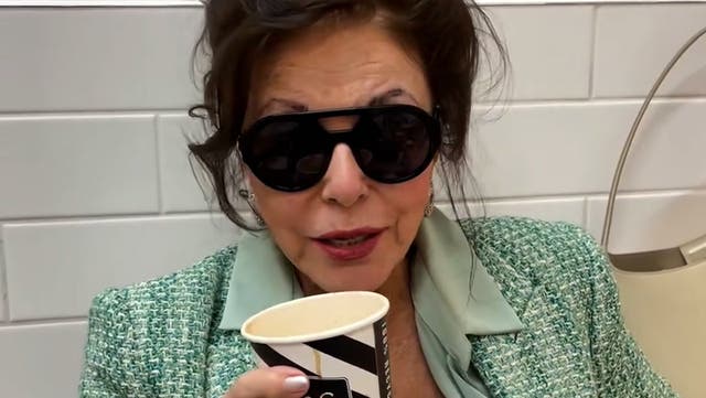 <p>Joan Collins sips on coffee while shopping in Marks and Spencer.</p>