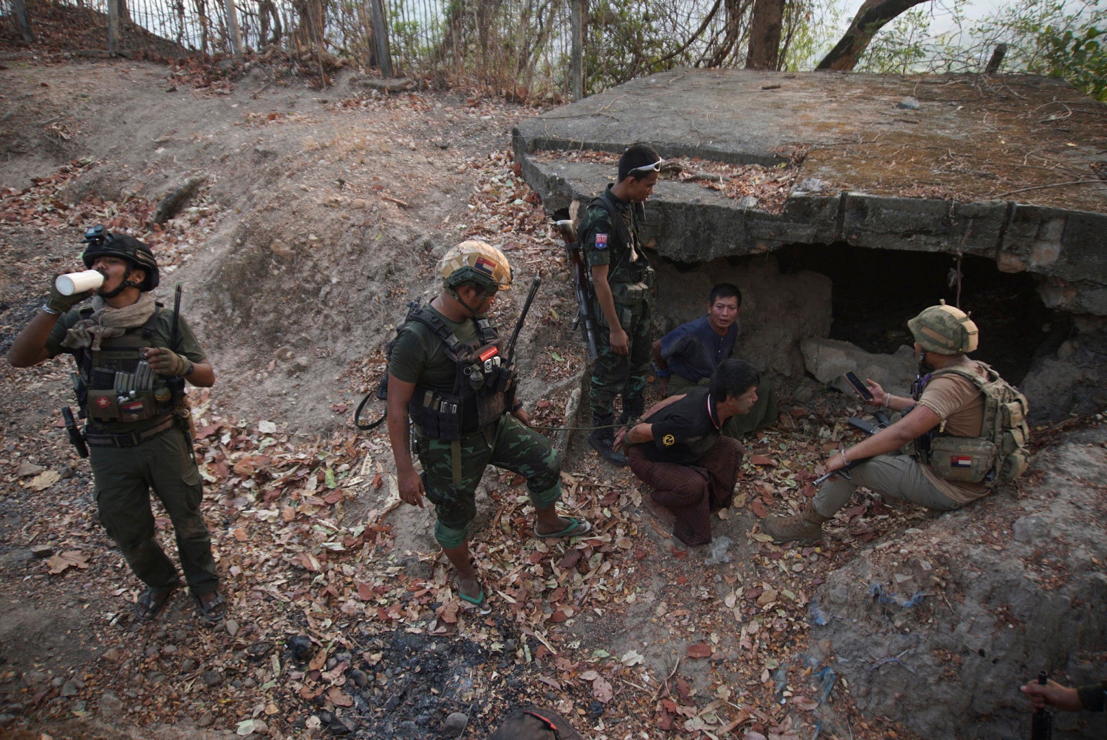 File. Fighters of the Karen National Liberation Army and the People's Defense Force examine arrested soldiers after capturing an army outpost in Myawaddy township of Myanmar