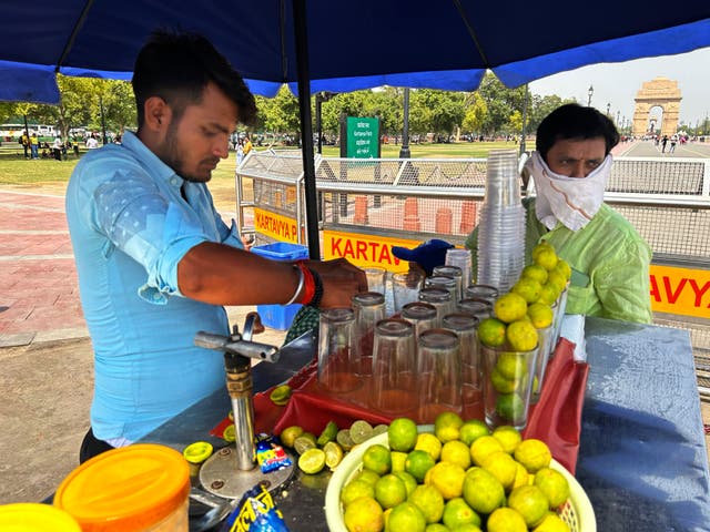 <p>A roadside vendor sells iced lemonade in Delhi as the Indian capital grapples with a severe heatwave</p>