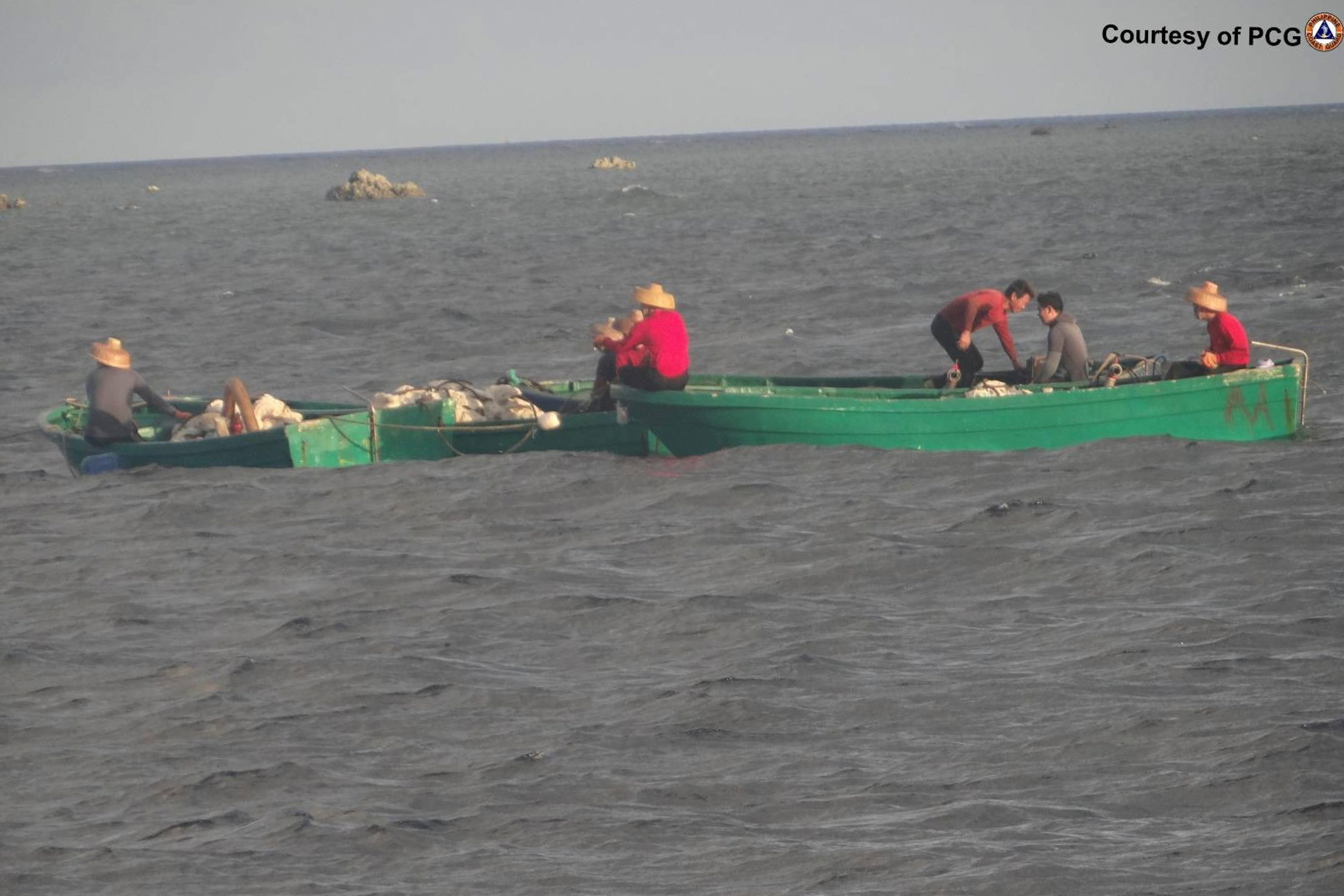 In this June 12, 2016 handout photo provided by the Philippine Coast Guard, suspected Chinese maritime militia transport giant clams which they got in the Scarborough shoal at the disputed South China Sea, the Philippine Coast Guard said