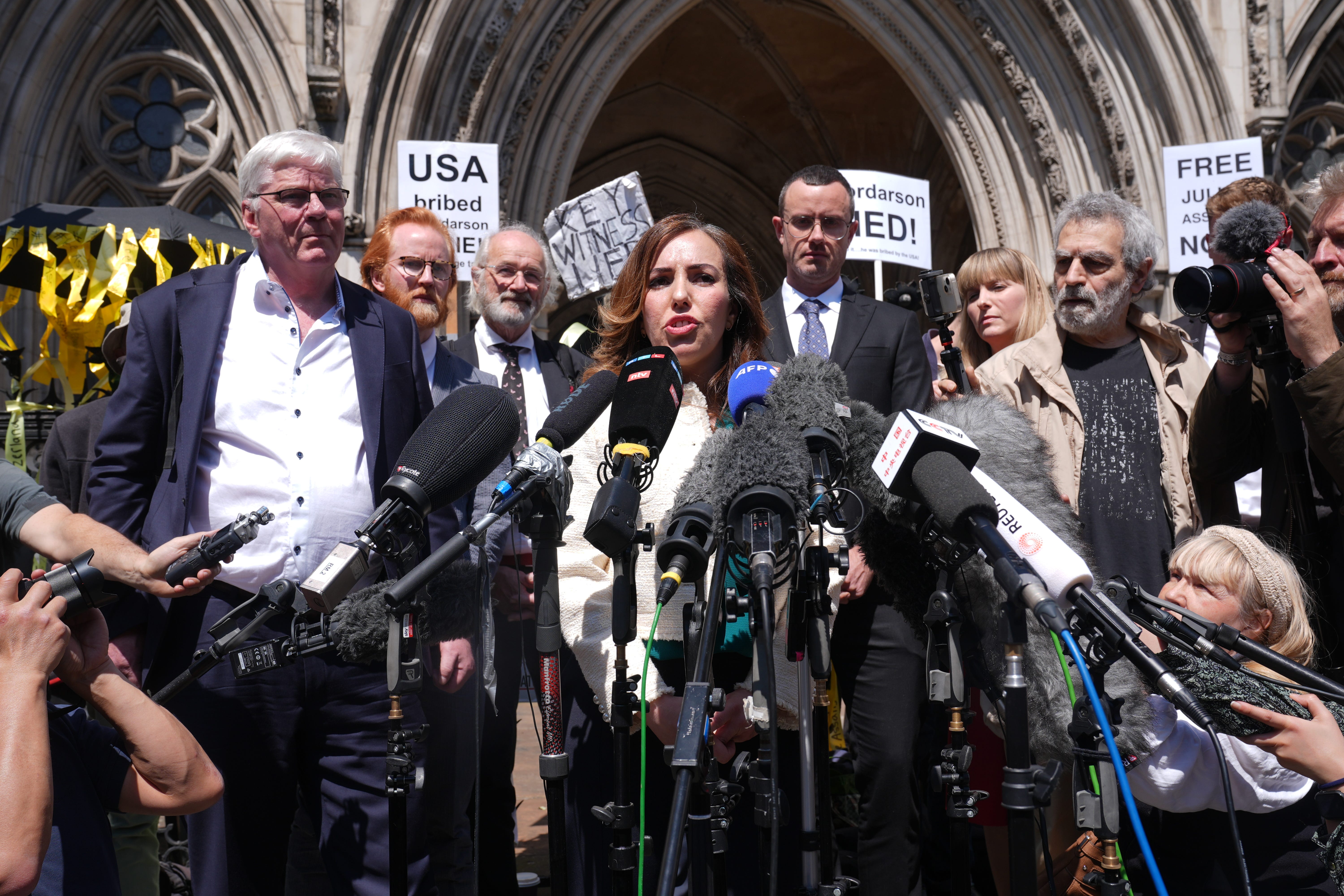 Stella Assange, the wife of Julian Assange, gives a statement outside the Royal Courts of Justice in London after her husband won a bid at the High Court to bring an appeal against his extradition to the US