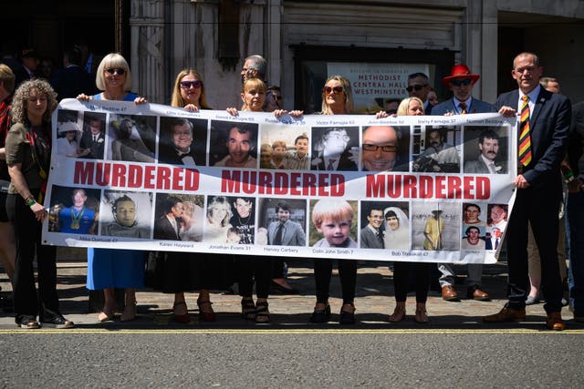 <p>Families affected by the infected blood scandal pose for photographs outside the Methodist Central Hall following the release of findings of the six-year inquiry</p>