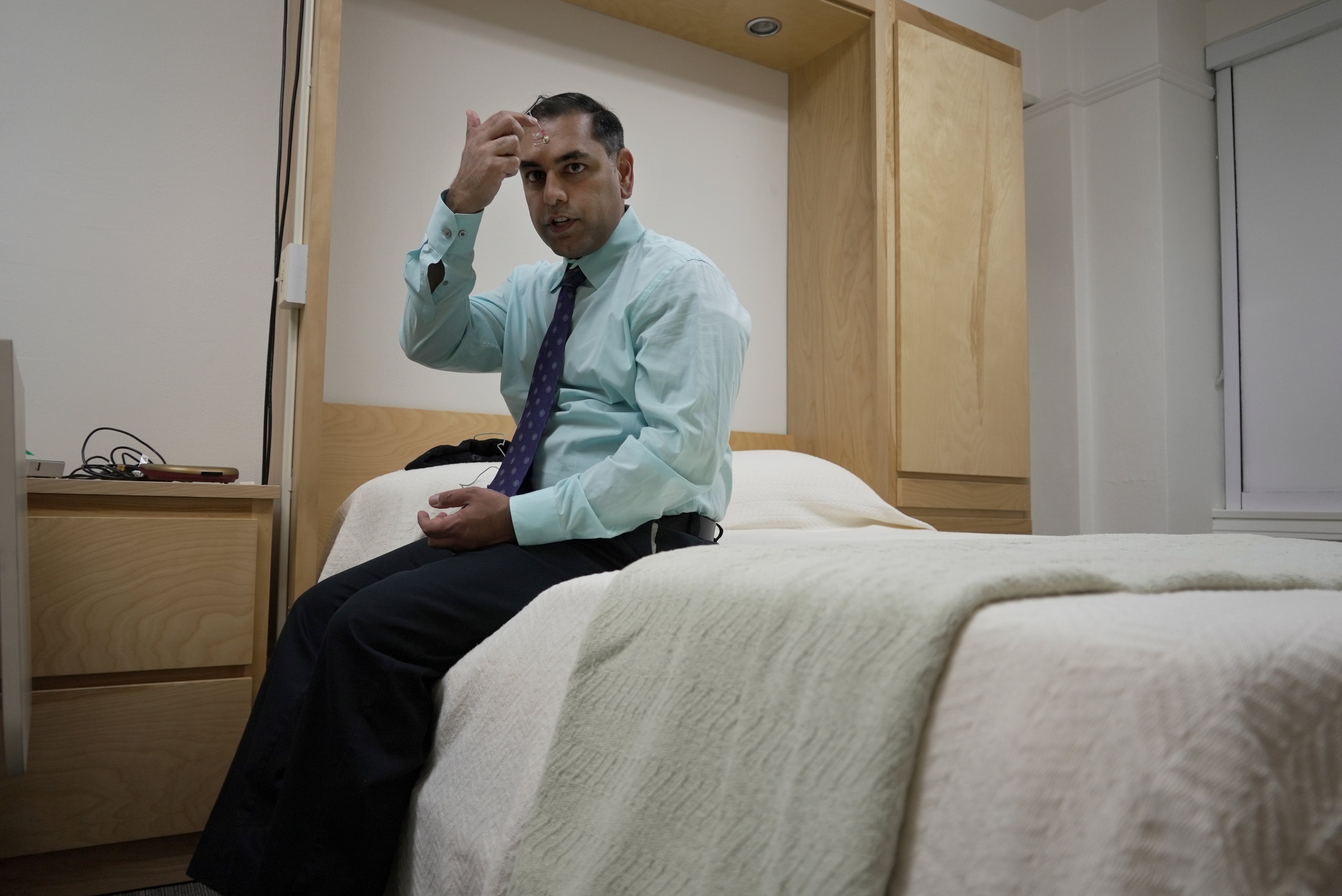 Dr. Roneil Malkani demonstrates the set up for a sleep study at the Center for Circadian & Sleep Medicine