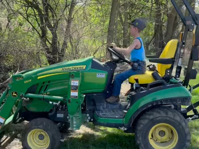 <p>Jackson of the ‘Just A Jackson Thing’ account showing viewers how to clean up debris with a tractor </p>